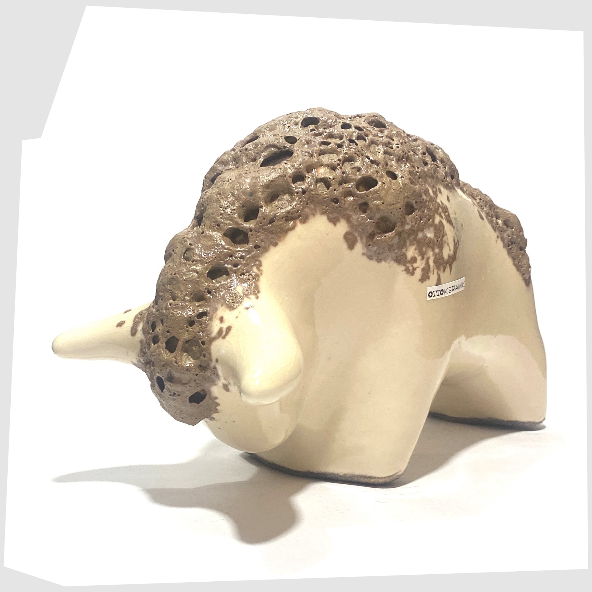 front of the otto keramik bull in off-white glaze with brown fat lava along the spine