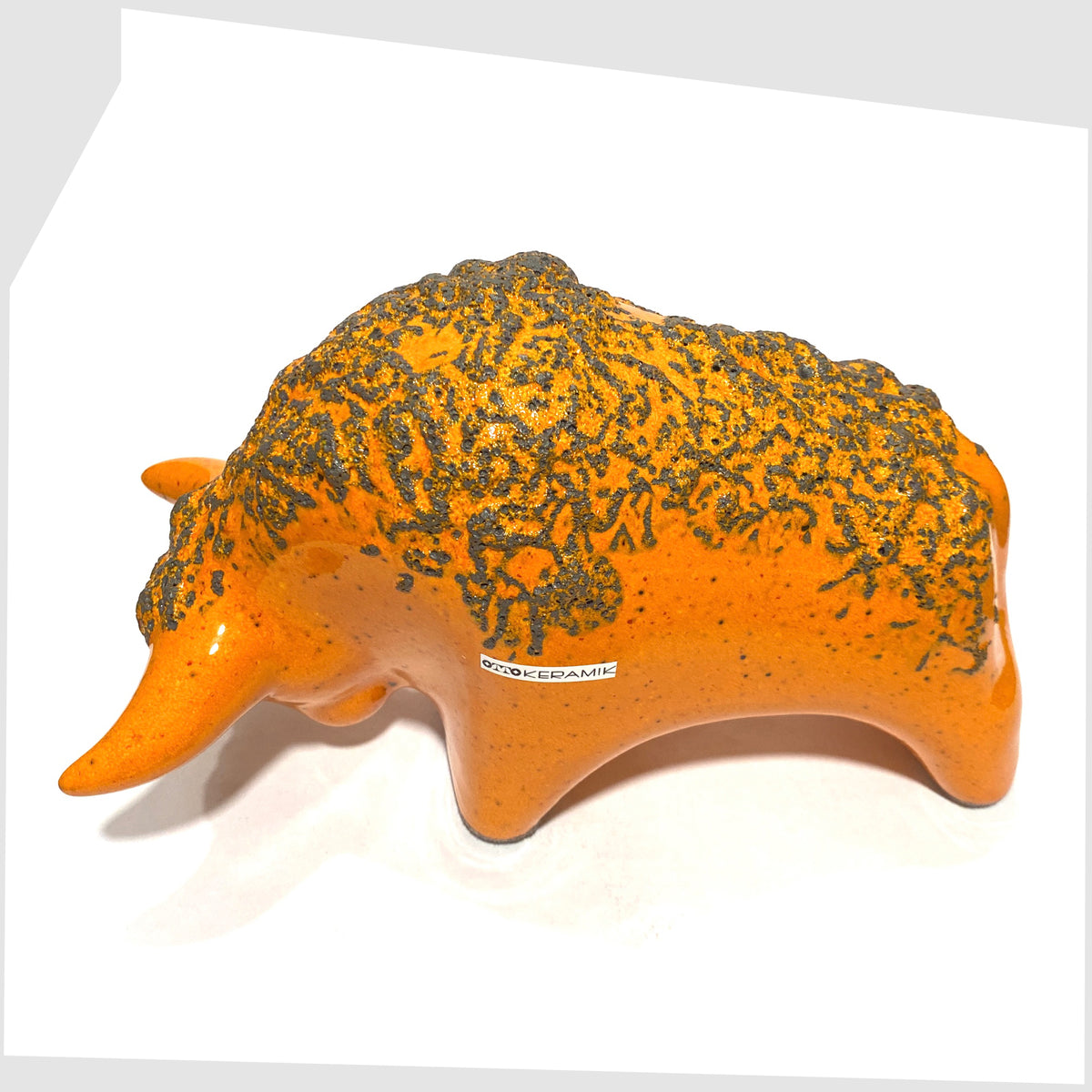 Back of the Otto Keramik Bull in Orange glaze with grey fat lava, shown on a white background