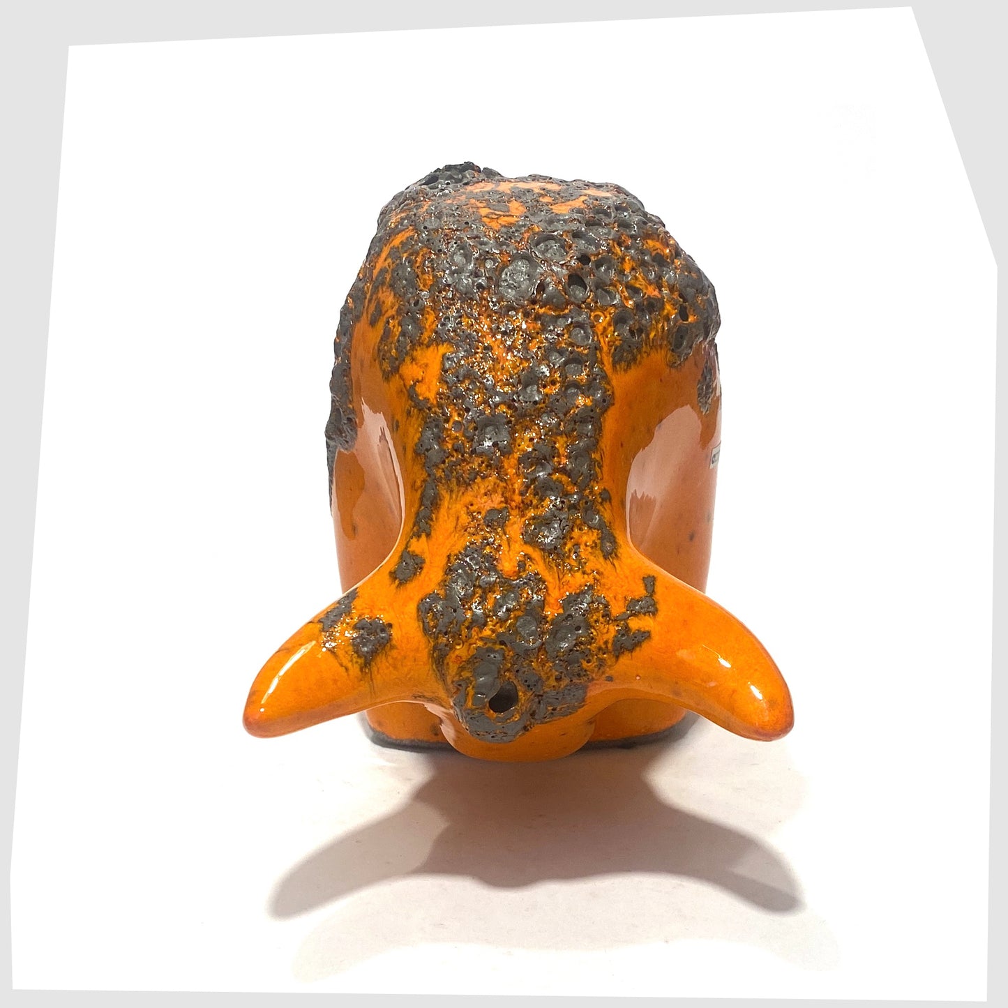 front horns of the Otto Keramik Bull in Orange Fat Lava showing the matte grey lava glaze on the orange gloss base