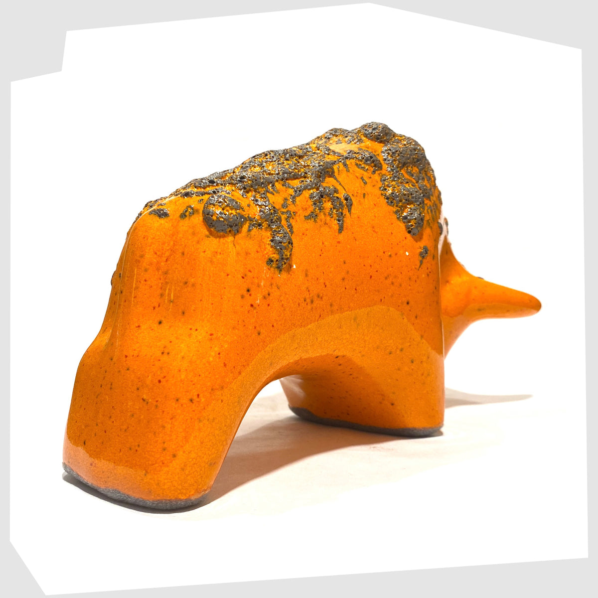 Rear of the Otto Keramik Bull in Orange Fat Lava Glaze, shown on a white background