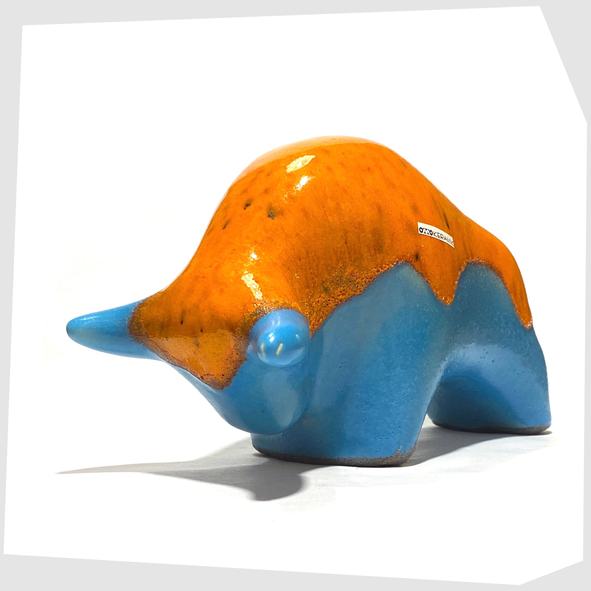 Front angle of the Otto Keramik Ceramic Bull in Orange Over Blue glaze, shown on a white background