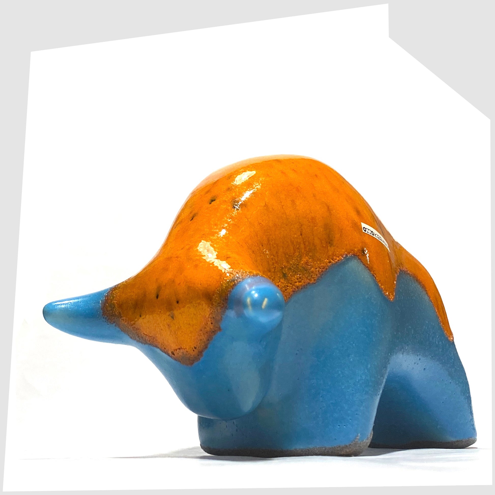 Front horns of the Otto Keramik Ceramic Bull in Orange Over Blue glaze, shown on a white background