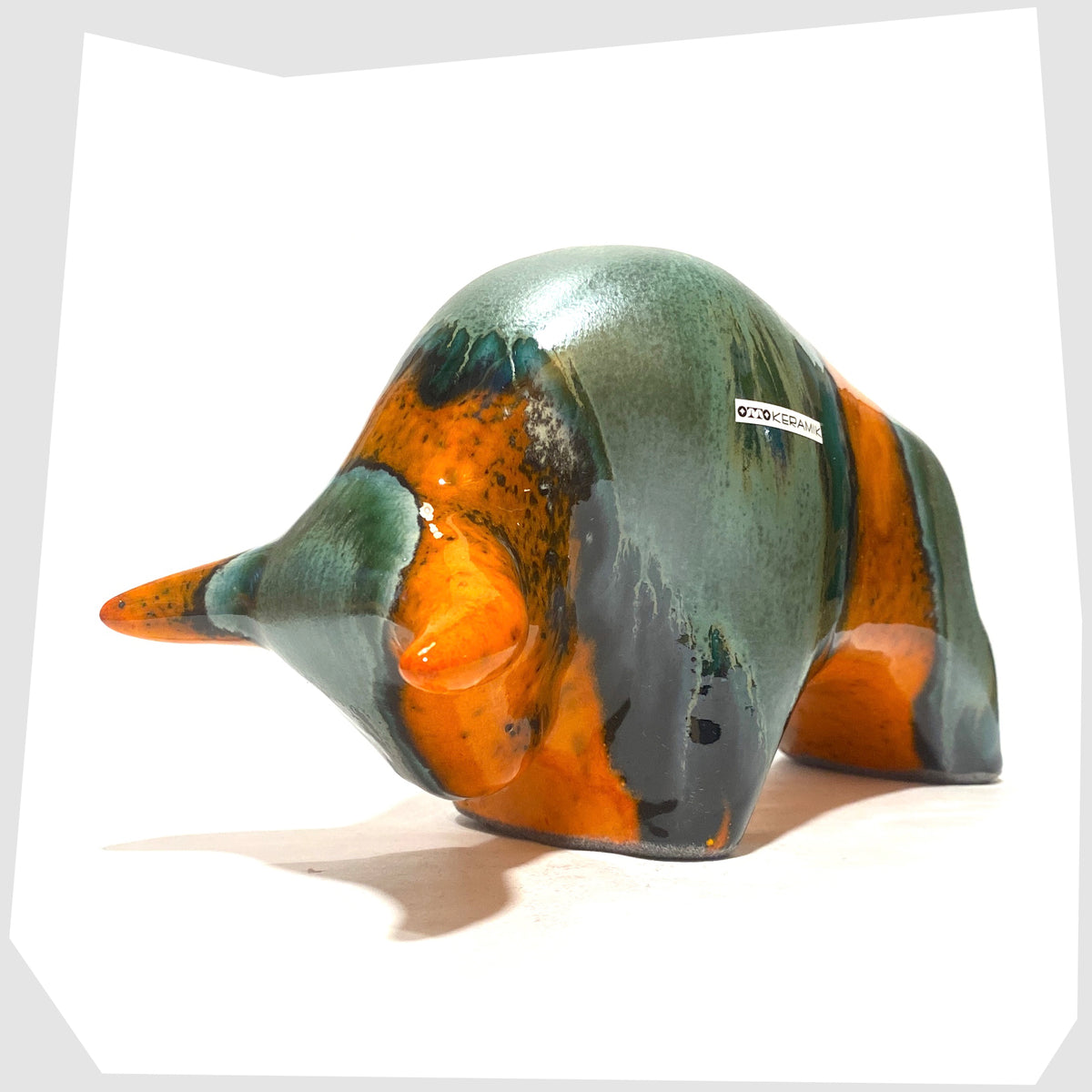 Front of the Otto Keramik Bull in Peru Glaze of orange with sea green bands, shown on a white background