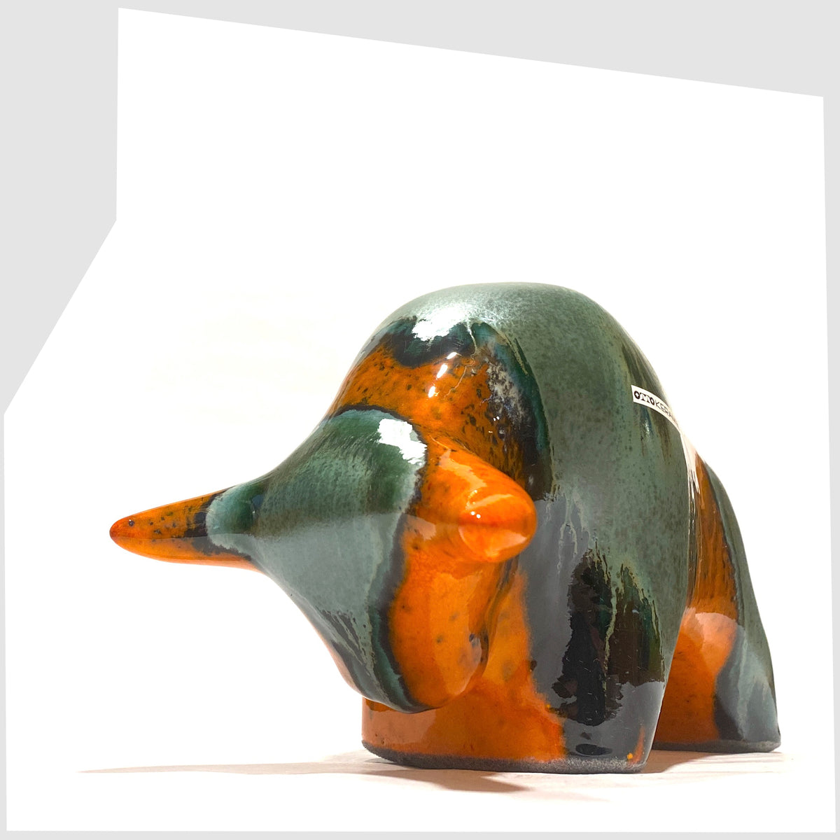 West German Pottery-style Otto Keramik Bull in Peru Glaze of orange with sea green bands, shown on a white background