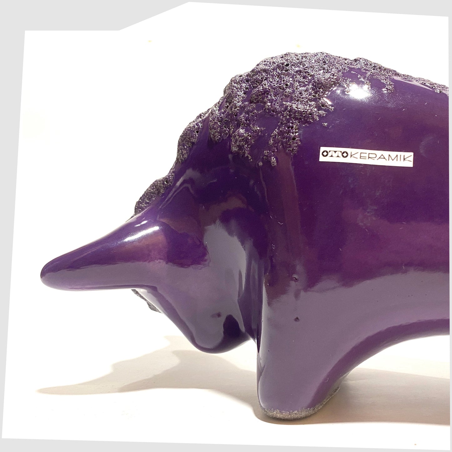 close up of the Otto Keramik Bull in purple glaze with deep fat lava along the spine