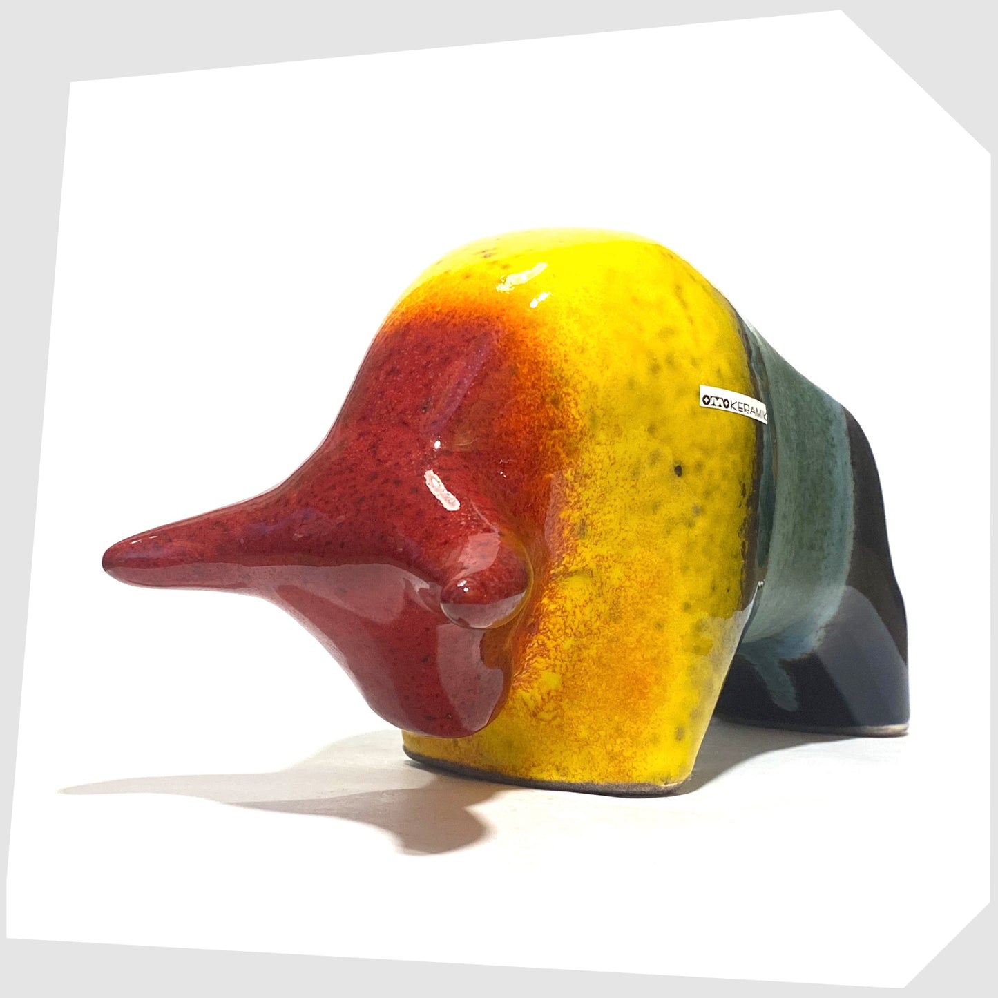 Front of the Otto Keramik ceramic bull in rainbow glaze of multicoloured stripes, shown on a white background