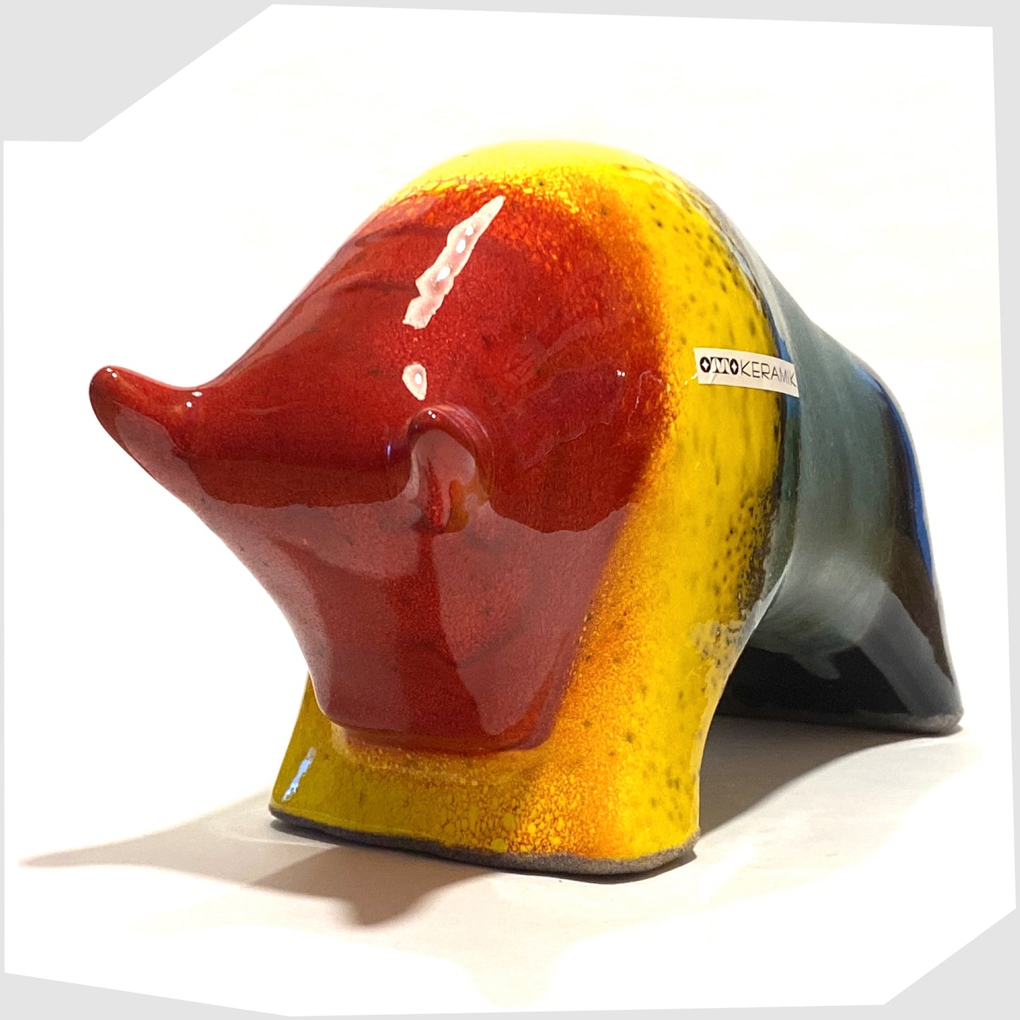 front horns of the large otto keramik bull in multicoloured rainbow, glazed with stripes of red, yellow, green and navy
