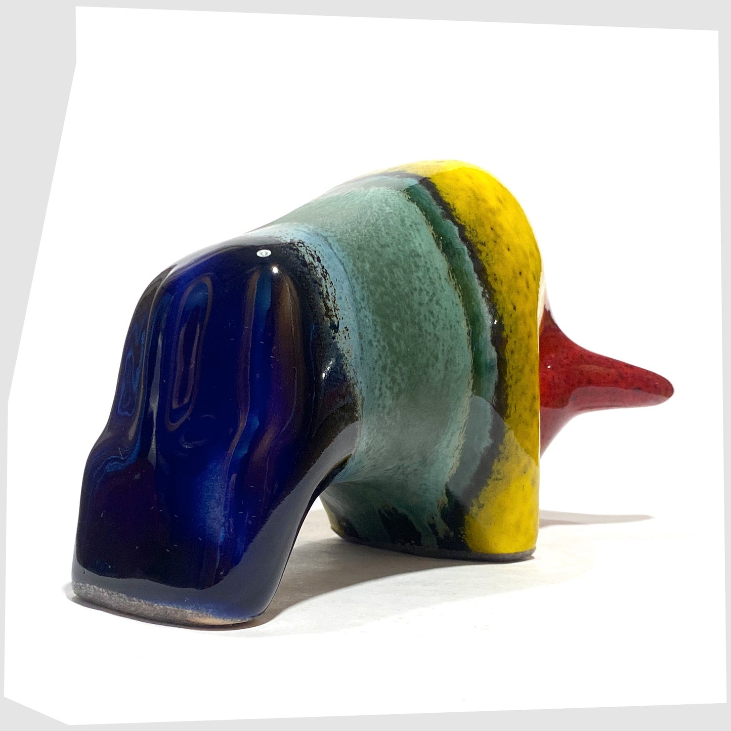 Rear of the Otto Keramik ceramic bull in rainbow glaze of multicoloured stripes, shown on a white background