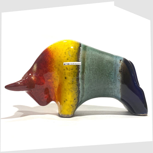 Otto Keramik ceramic bull in rainbow glaze of multicoloured stripes, shown on a white background