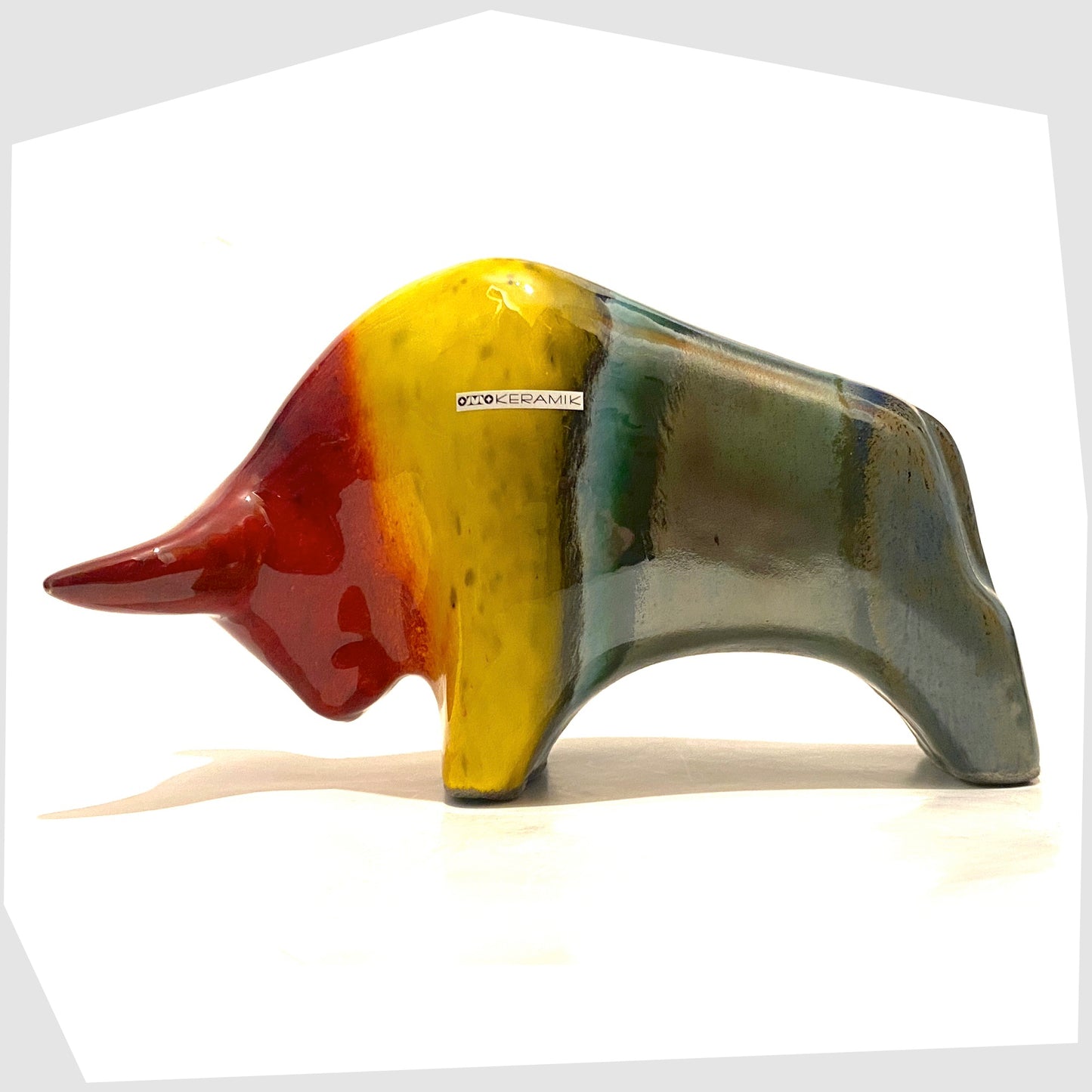 otto keramik ceramic bull in rainbow glaze of red, yellow and sea green stripes