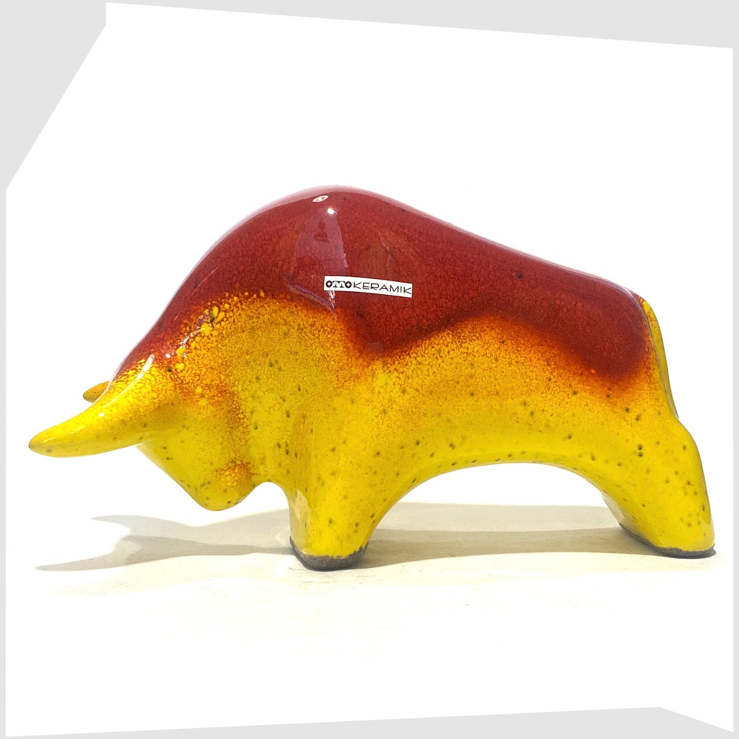 otto keramik bull-shaped sculpture in red over yellow glaze