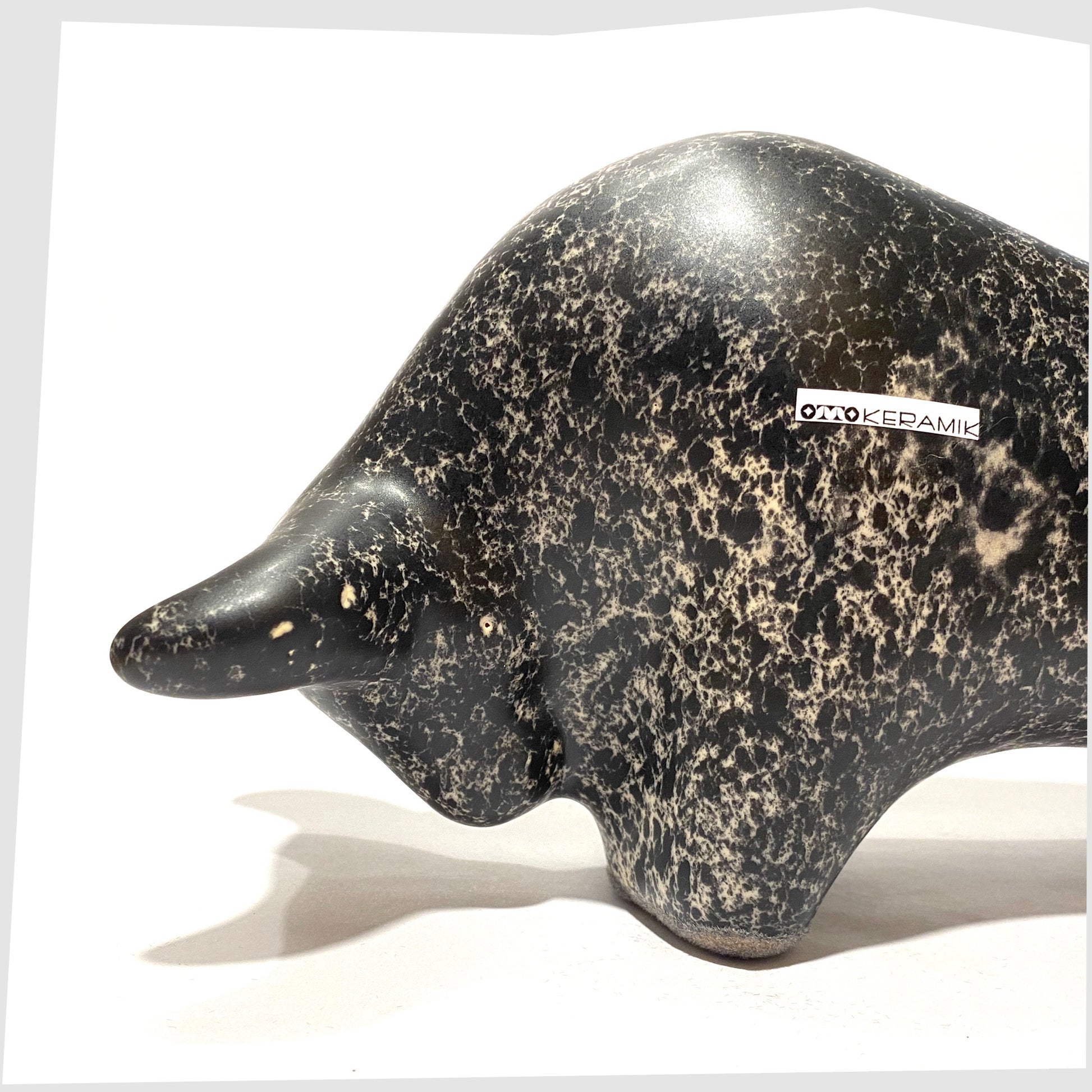 close up of the otto keramik bull in black speckled glaze with cream flecks