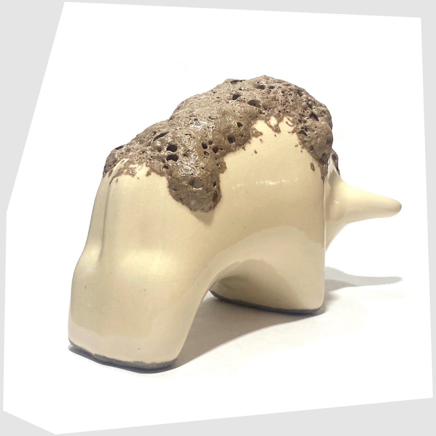 rear of the otto keramik bull in off-white glaze with brown fat lava along the spine