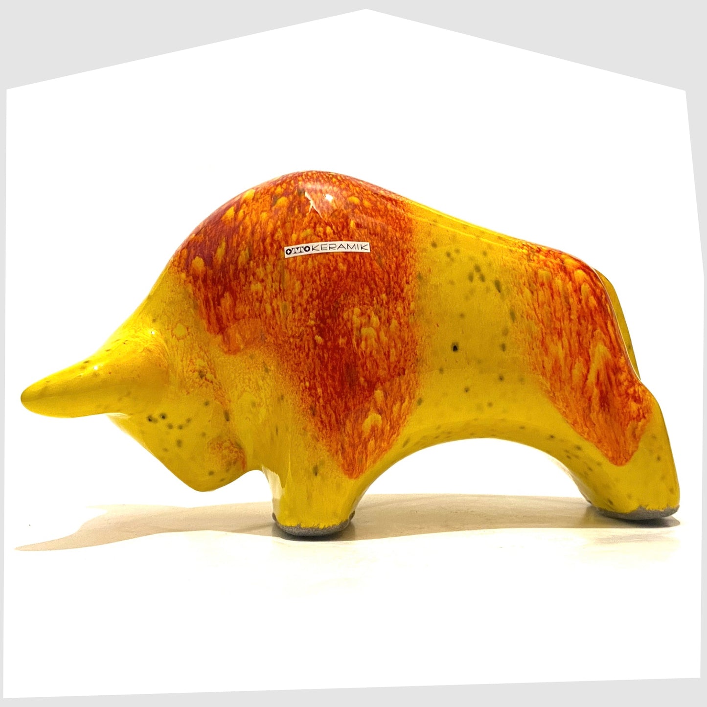 otto keramik bull glazed in a vibrant yellow glaze with burnt orange bands