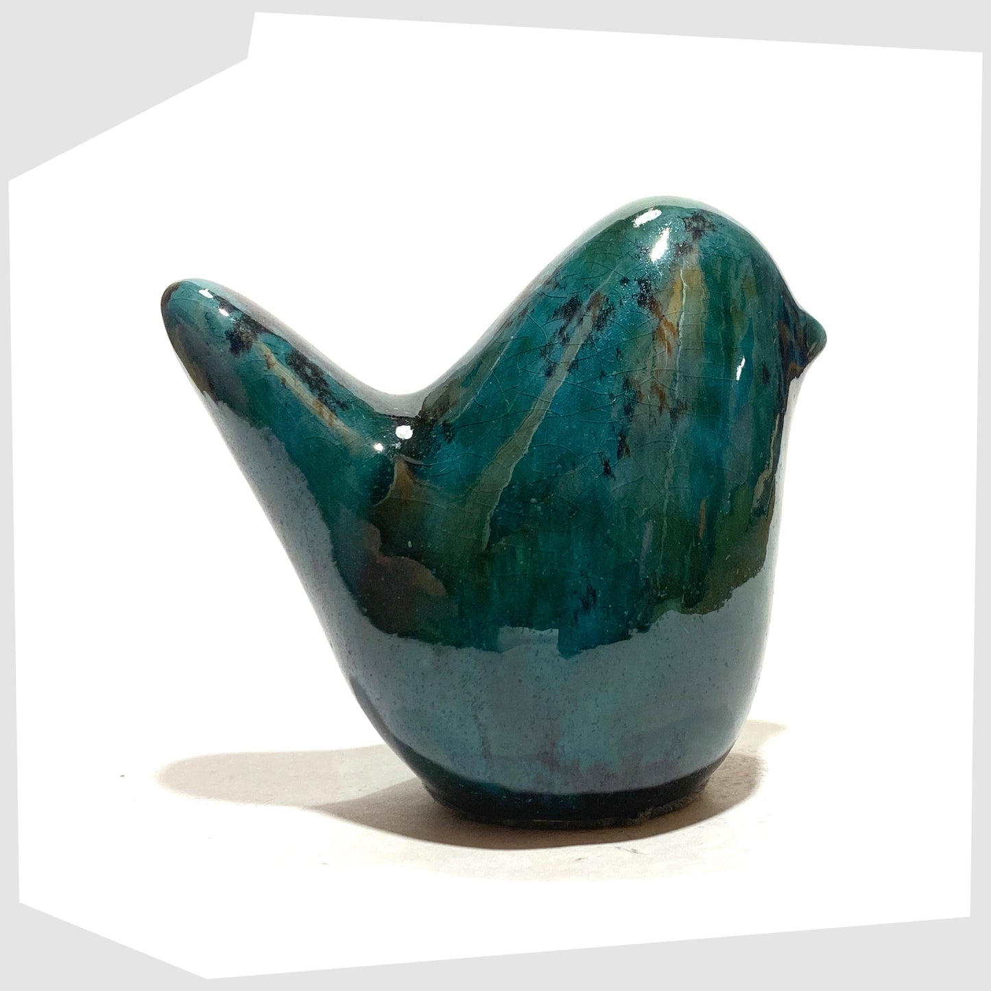 otto keramik bird in Ecuador glaze consisting of vibrant teal and deep black glaze