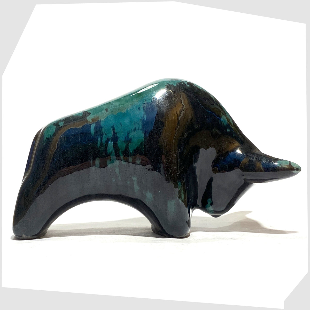 Otto Keramik Bull shaped ornament in Ecuador glaze of gloss black and teal, shown on a white background