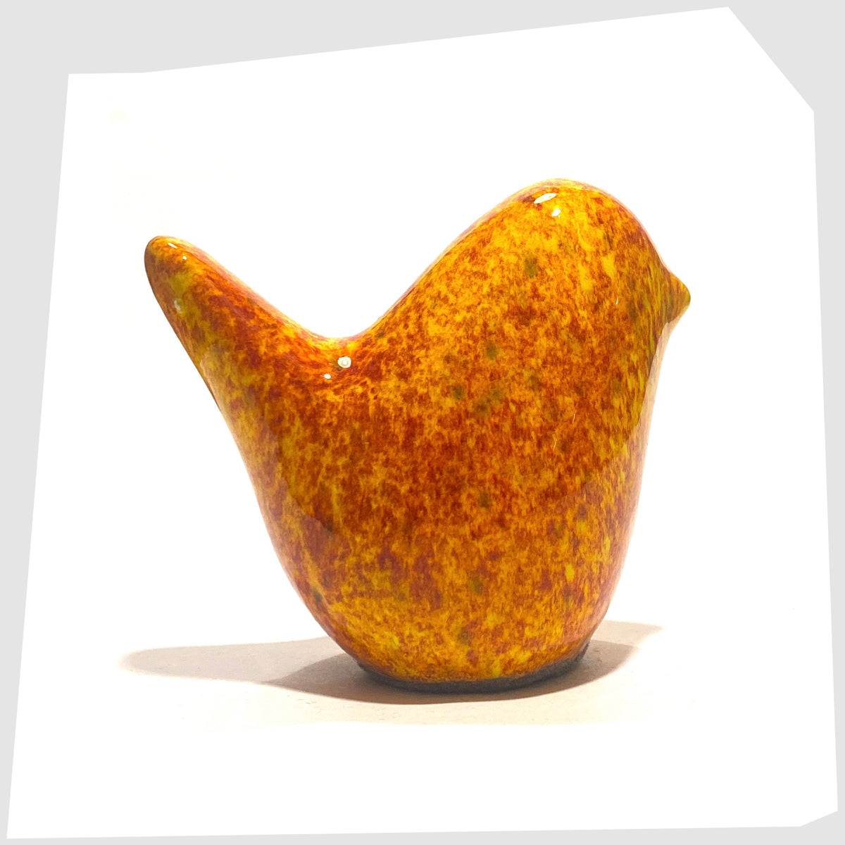 West German Pottery-style Otto Keramik Bird in Fire glaze of orange, red and yellow flecks, shown on a white background