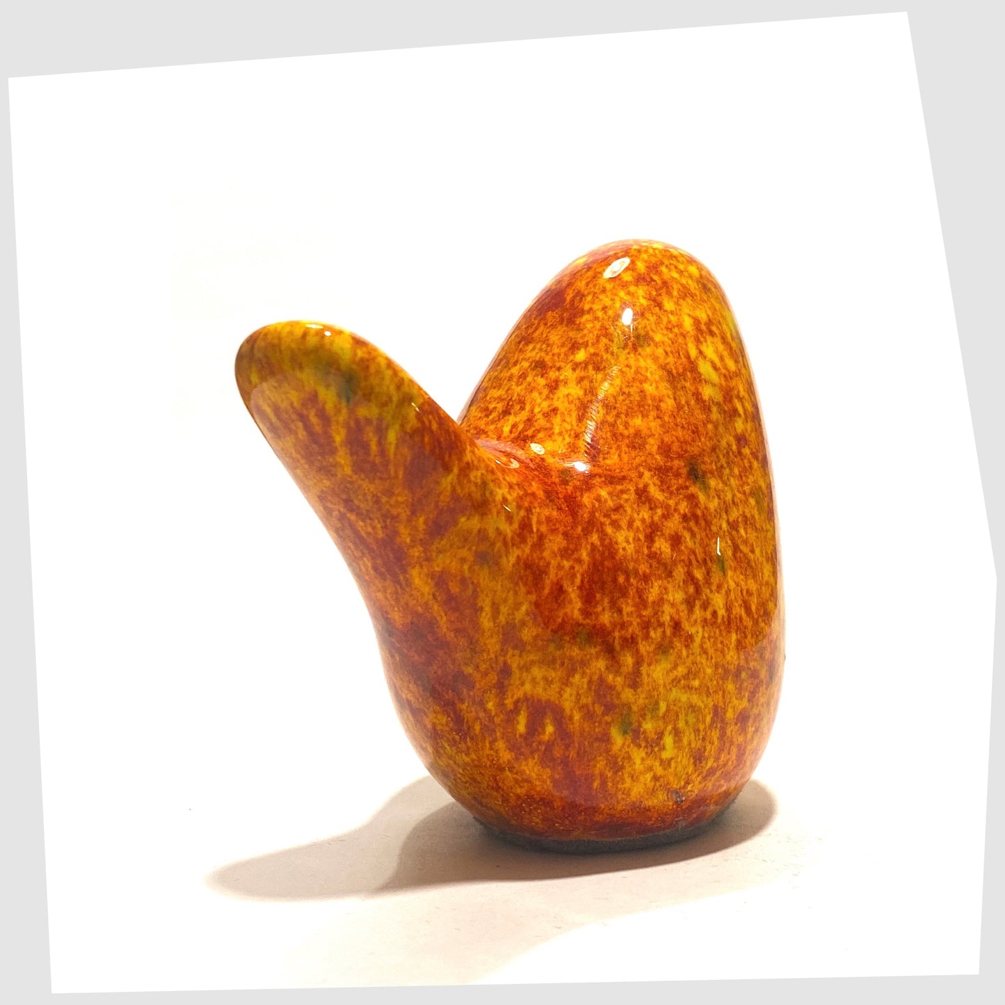 tail of the otto keramik ceramic bird in fire glaze of red, orange and yellow speckles