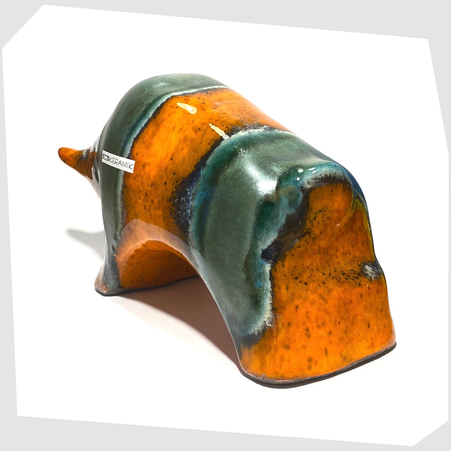 rear of the otto keramik large bull in orange and sea green drip glazing