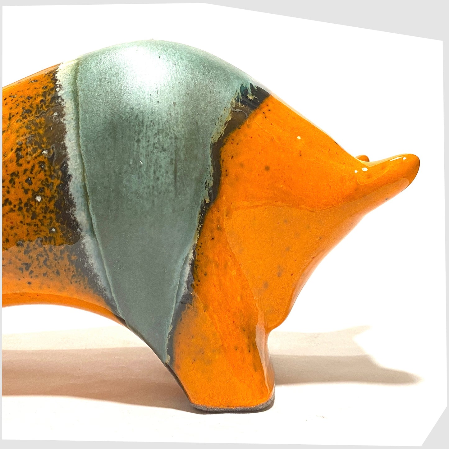 close up of the Otto Keramik ceramic bull in orange and sea green 'Peru' glaze