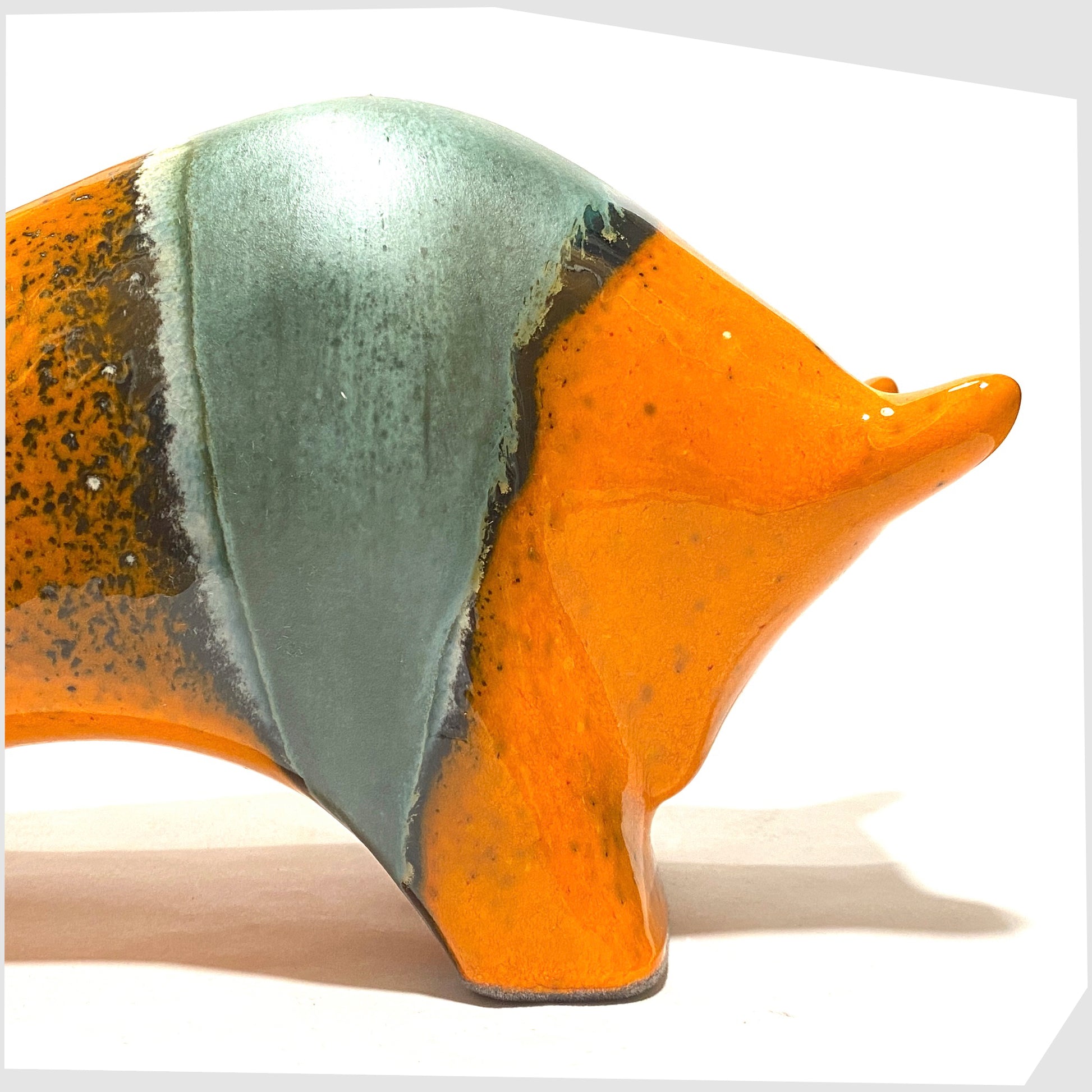 close up of the Otto Keramik ceramic bull in orange and sea green 'Peru' glaze