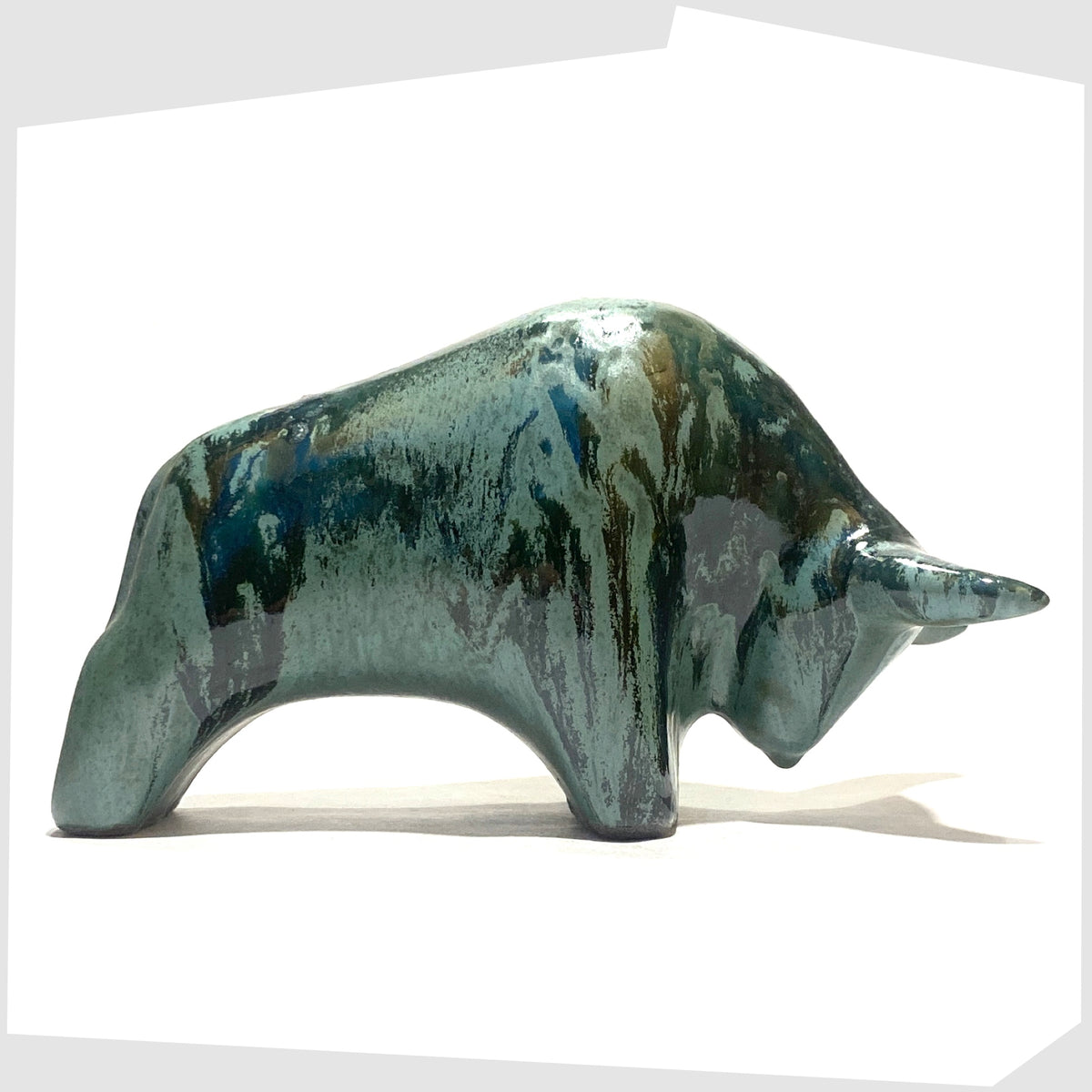 West German Pottery-inspired Otto Keramik Bull shaped figurine in Malta glaze of rich sea green with darker drip glazing, shown on a white background