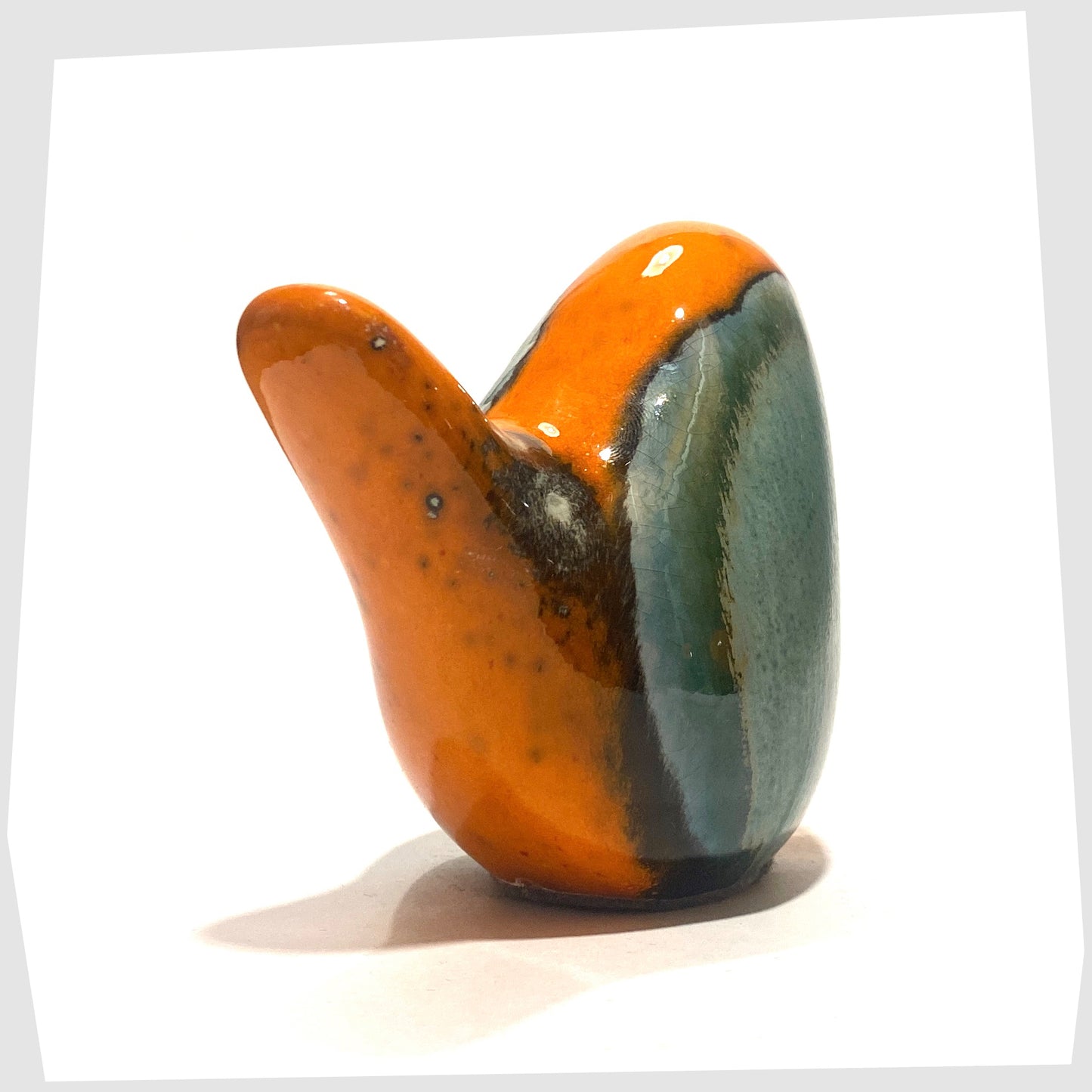 tail of the ceramic bird in peru glaze of orange and sea green by otto keramik, germany