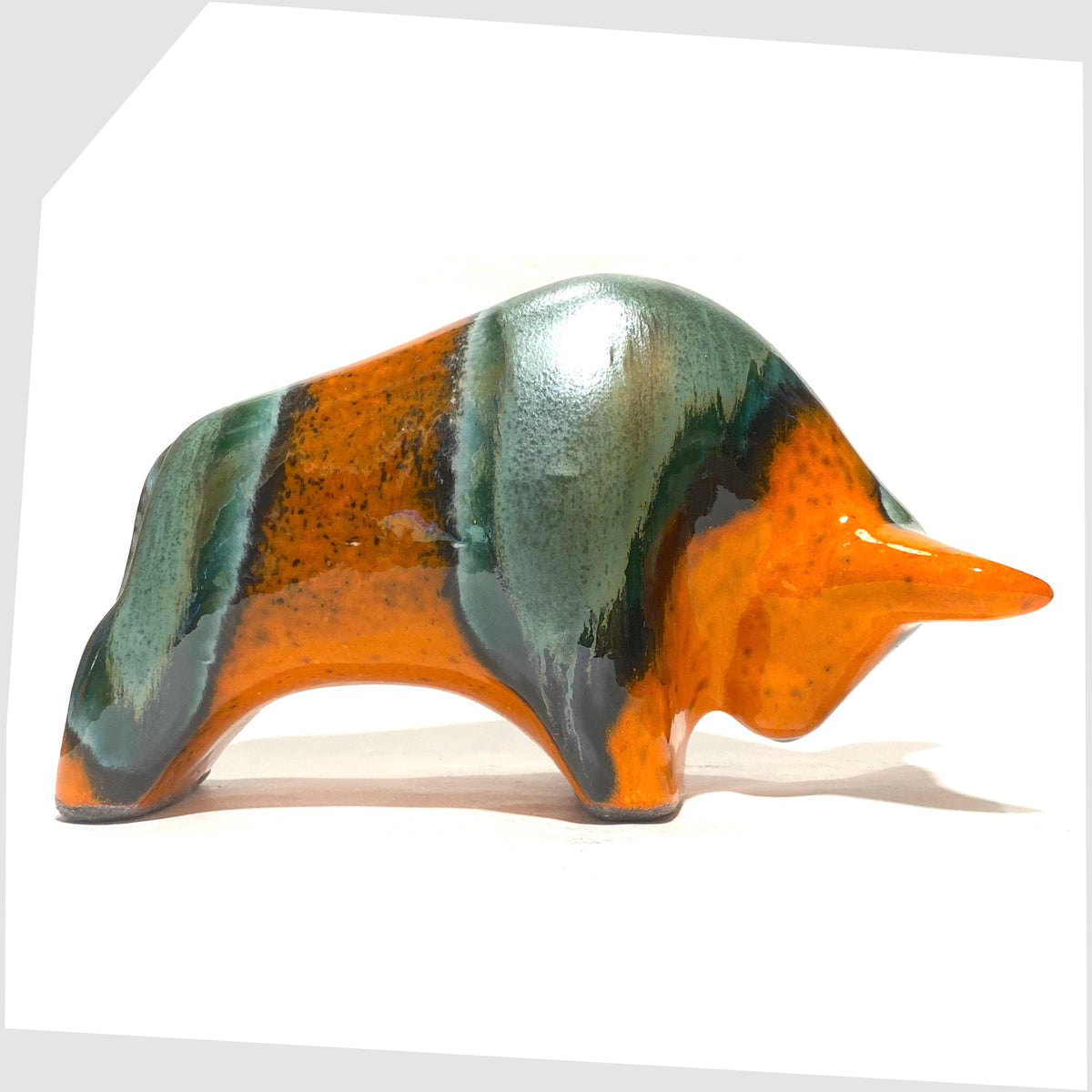 Otto Keramik Ceramic Bull in Peru Glaze of orange with sea green bands, shown on a white background