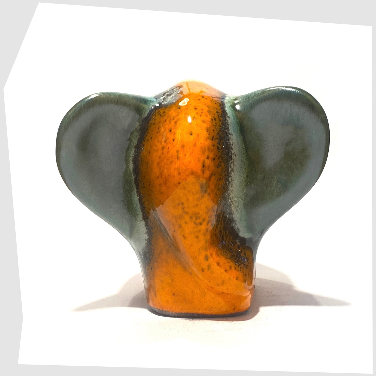 ceramic elephant sculpture by otto keramik in peru glaze of orange with sea green
