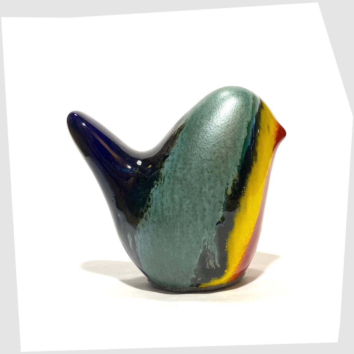 west german pottery-style ceramic bird in rainbow coloured glaze by otto keramik shown on a white background