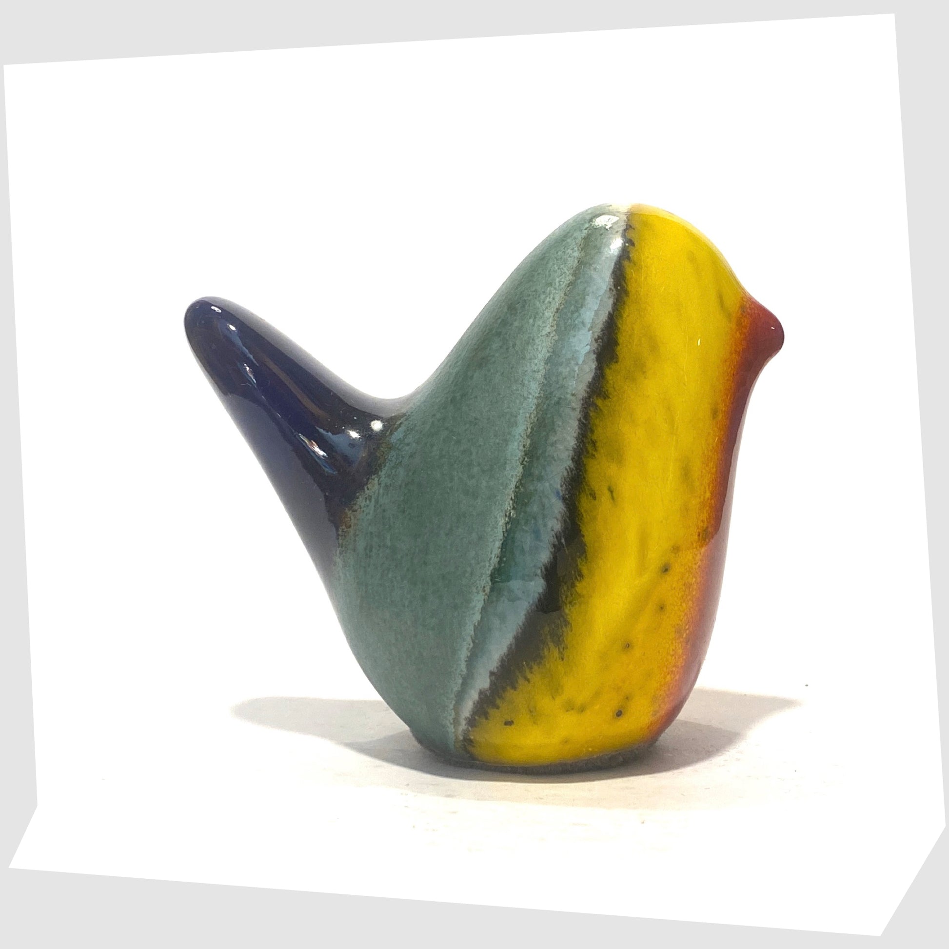 west german pottery-style ceramic bird in rainbow coloured glaze by otto keramik shown on a white background