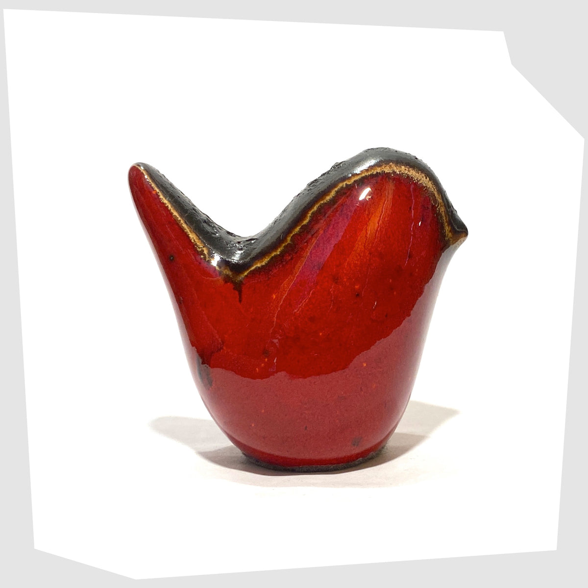 West German Pottery-inspired Otto Keramik ceramic bird in red glaze with grey fat lava along the spine, shown on a white background