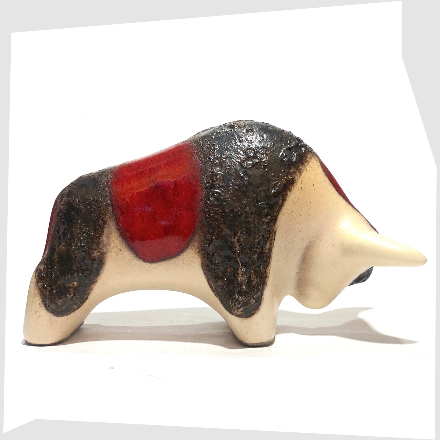 West German Pottery-style Otto Keramik ceramic bull in red and cream glaze with bands of thick fat lava, shown on a white background