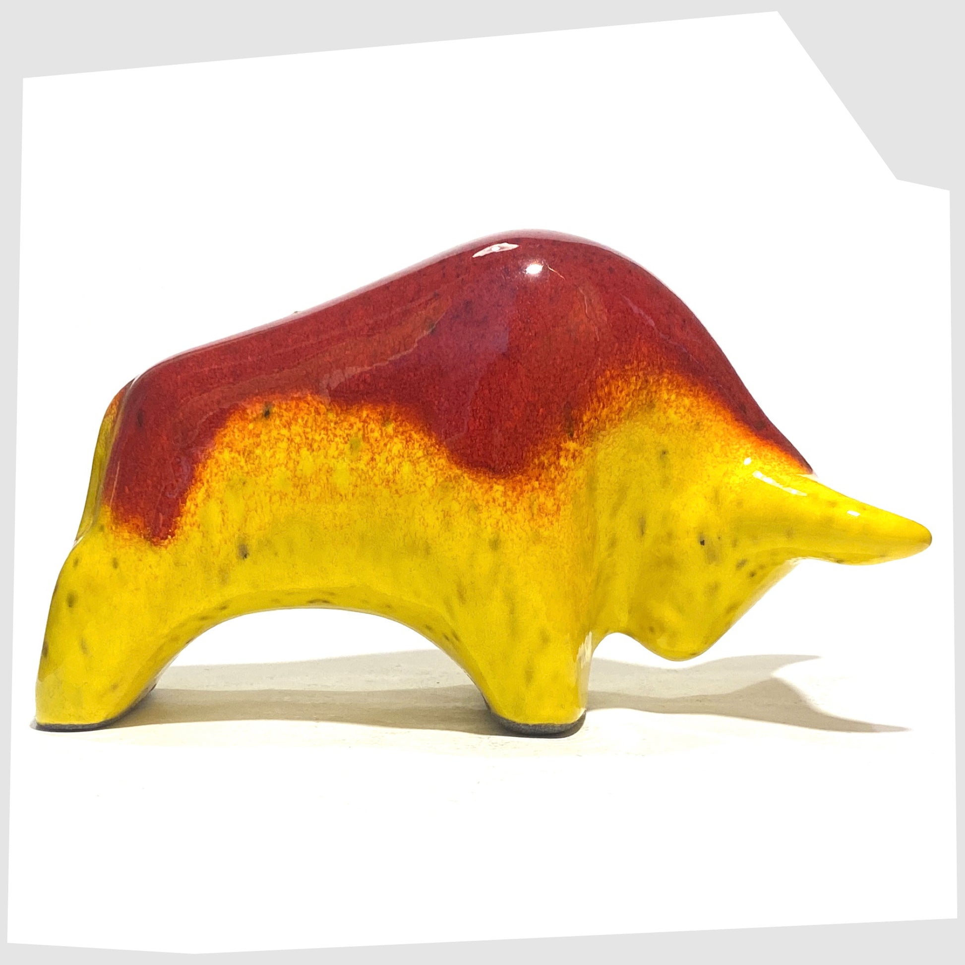 Otto Keramik Ceramic Bull-shaped figurine in vibrant red over yellow glaze shown on a white background