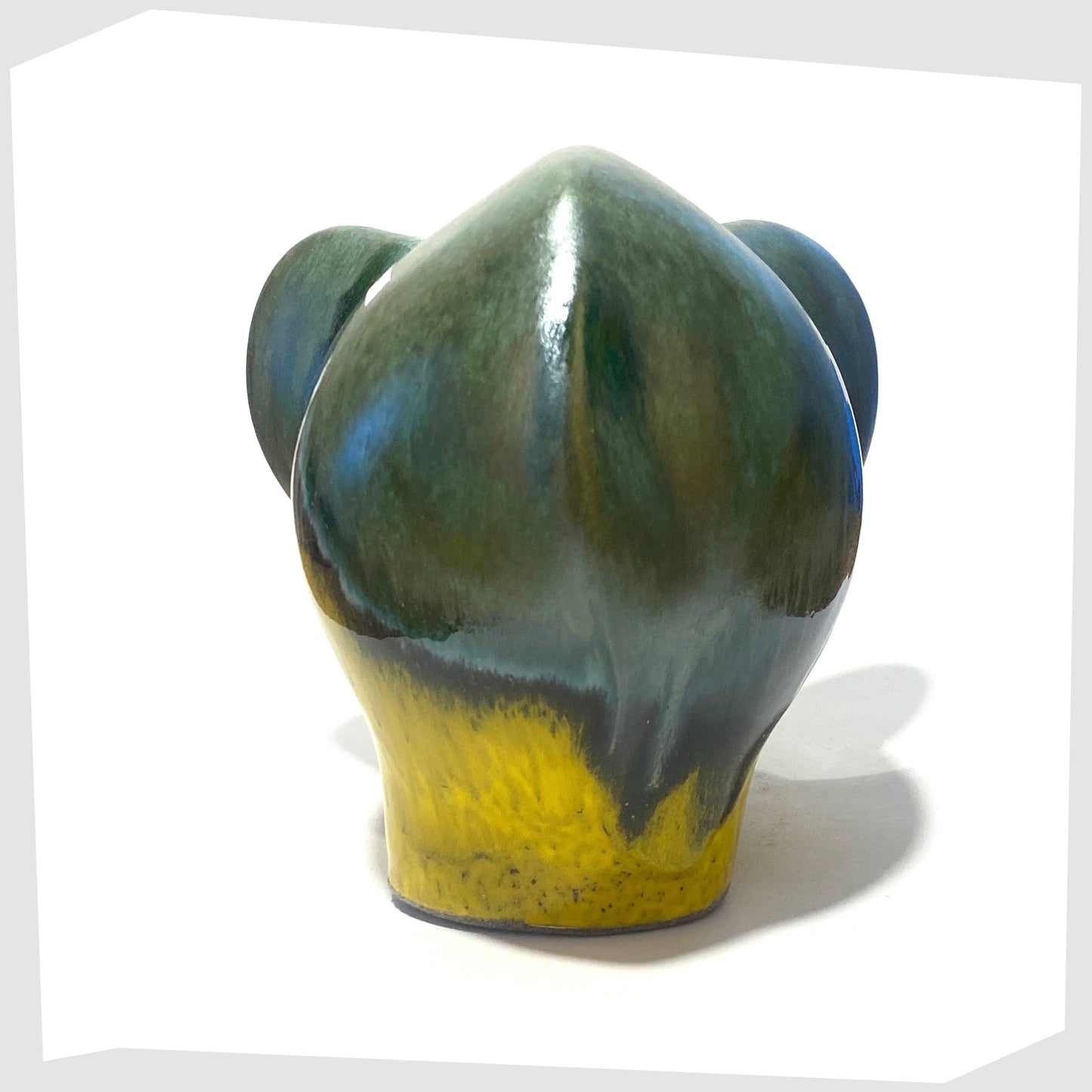 rear of the otto keramik ceramic elephant sculpture in Brazil glaze of vibrant yellow and rich sea green