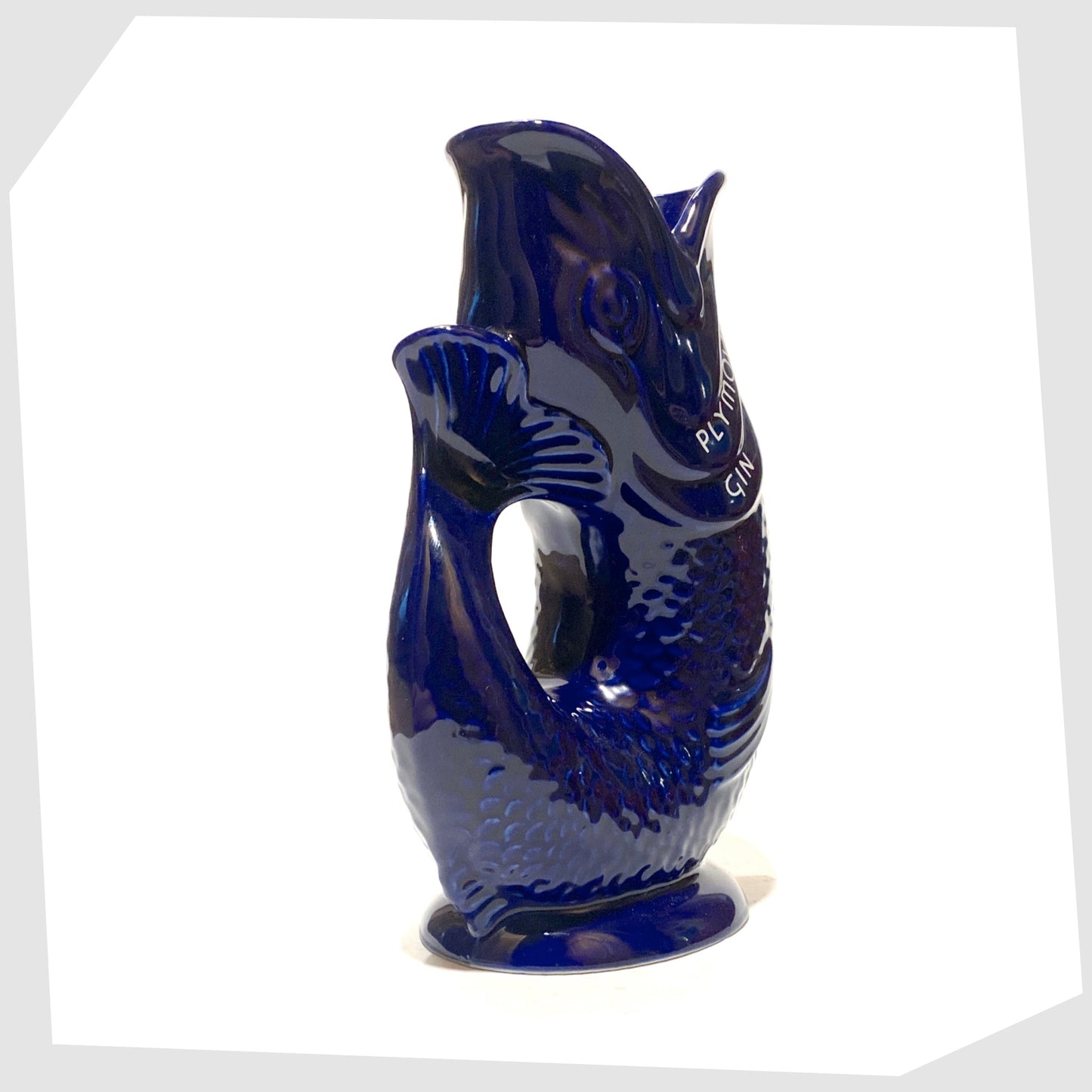 tail of the artefact of wade ceramics, plymouth gin gluggle jug in cobalt blue glaze with white text