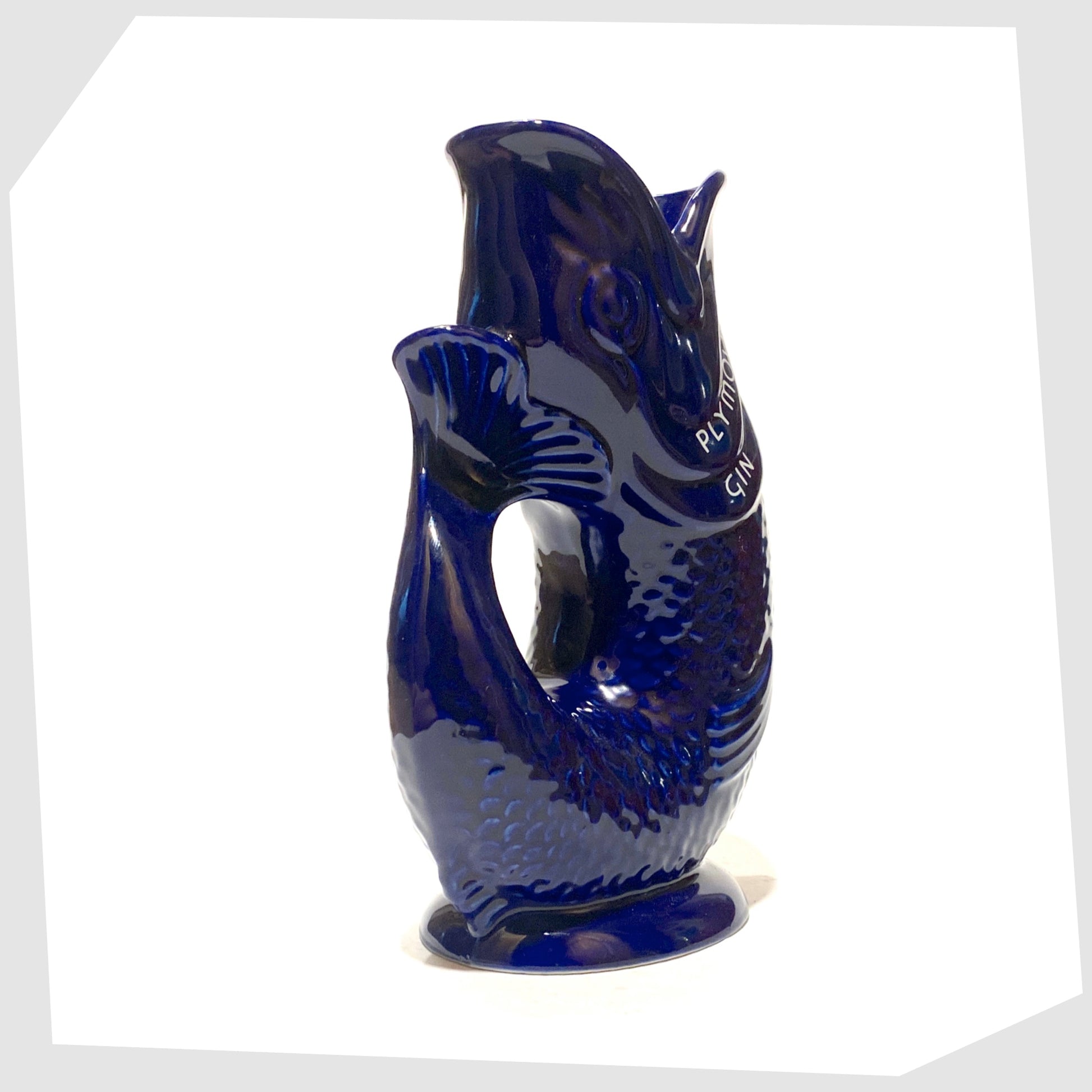 tail of the artefact of wade ceramics, plymouth gin gluggle jug in cobalt blue glaze with white text