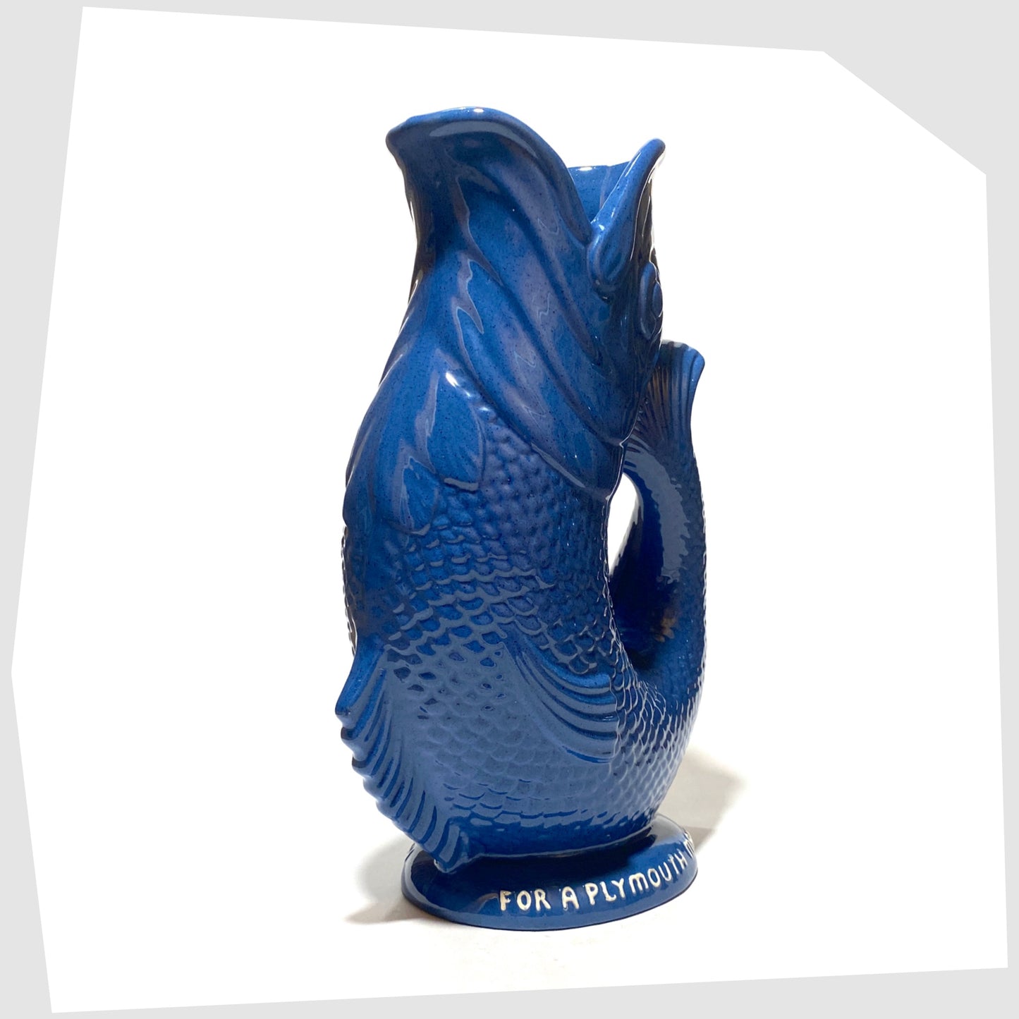 front of the original Dartmouth Pottery Gluggle Jug in blue glaze with "for a Plymouth man' on the base rim