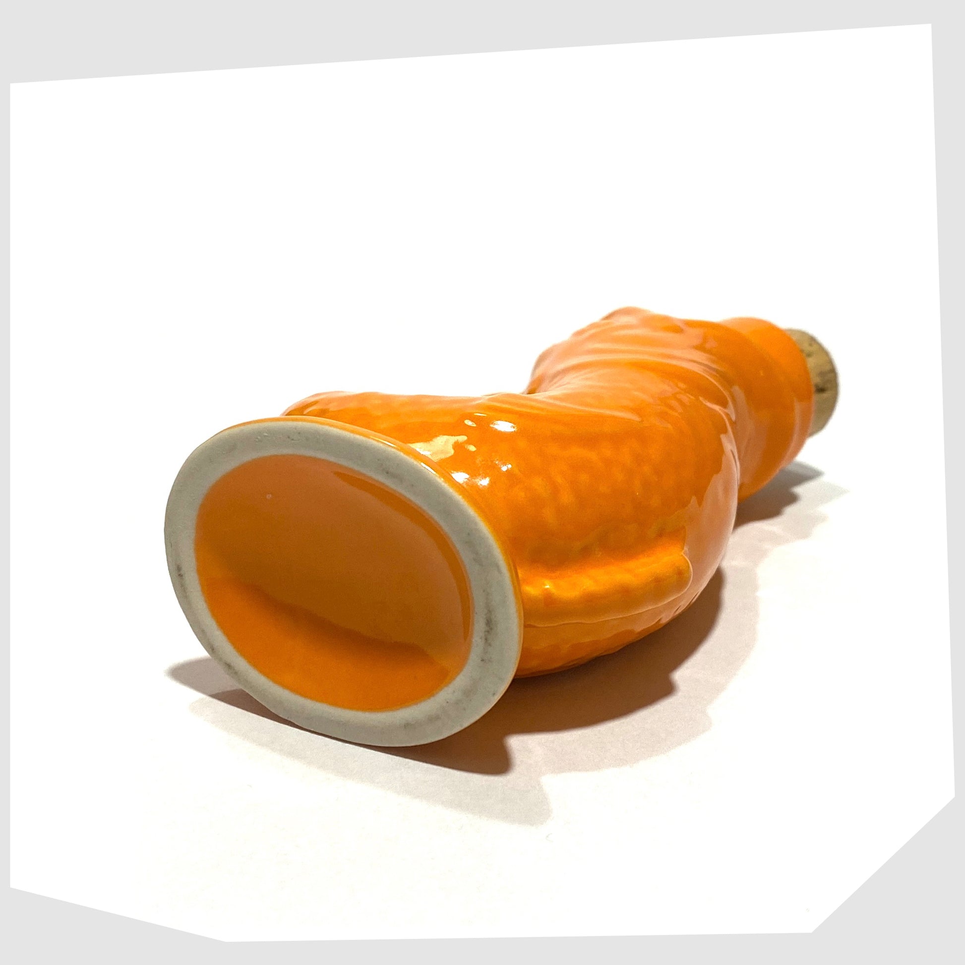 base of the plymouth gin mini gluggle jug in vibrant orange glaze with cork stopper