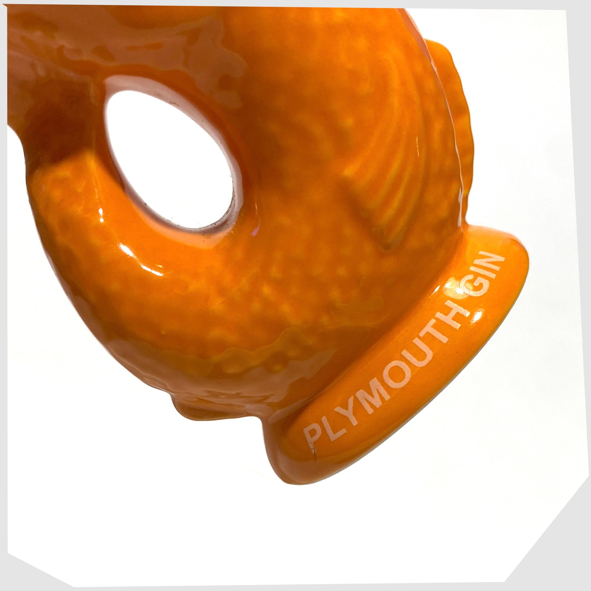 Plymouth Gin text around the base of the mini gluggle jug in vibrant orange glaze with cork stopper