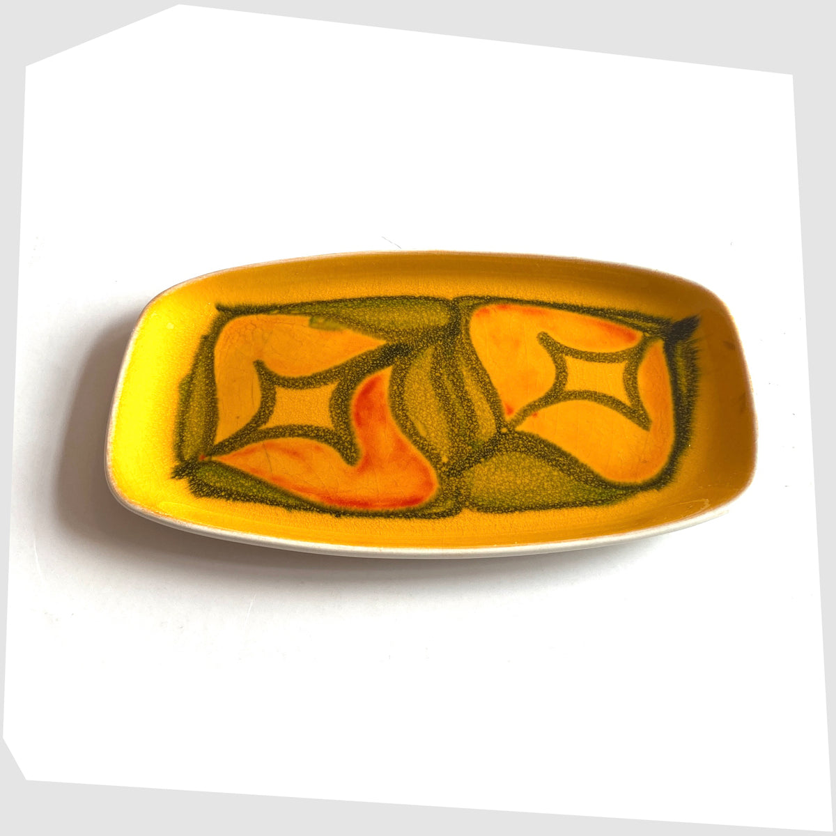 Poole Pottery Delphis Pin Dish by Lynn Gregory in a vibrant yellow glaze with free-form shapes of orange and green, shown on a white background