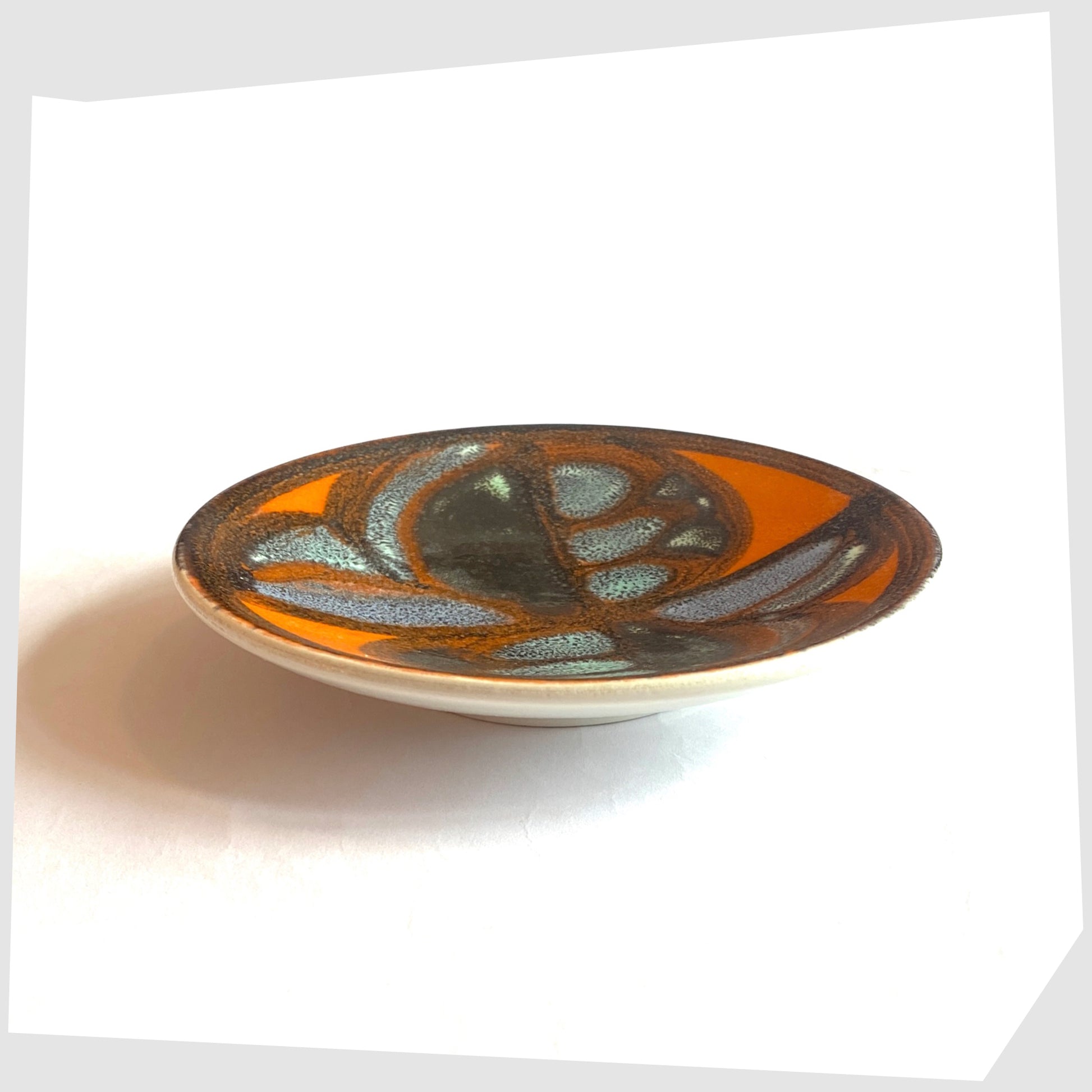 side profile of the Poole Pottery Delphis Pin Dish, Shape 49, finished in a rich orange glaze with blue and turquoise forms