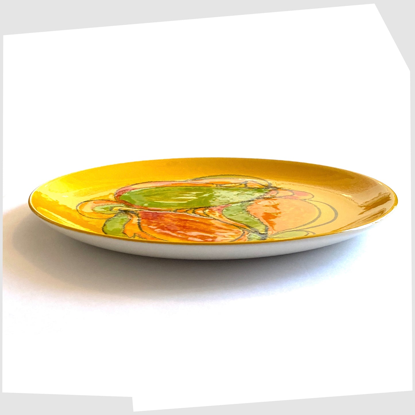 side profile of the Poole Pottery Delphis Plate, shape 4A, in a bold yellow glaze with flowing shapes of green, orange and red.