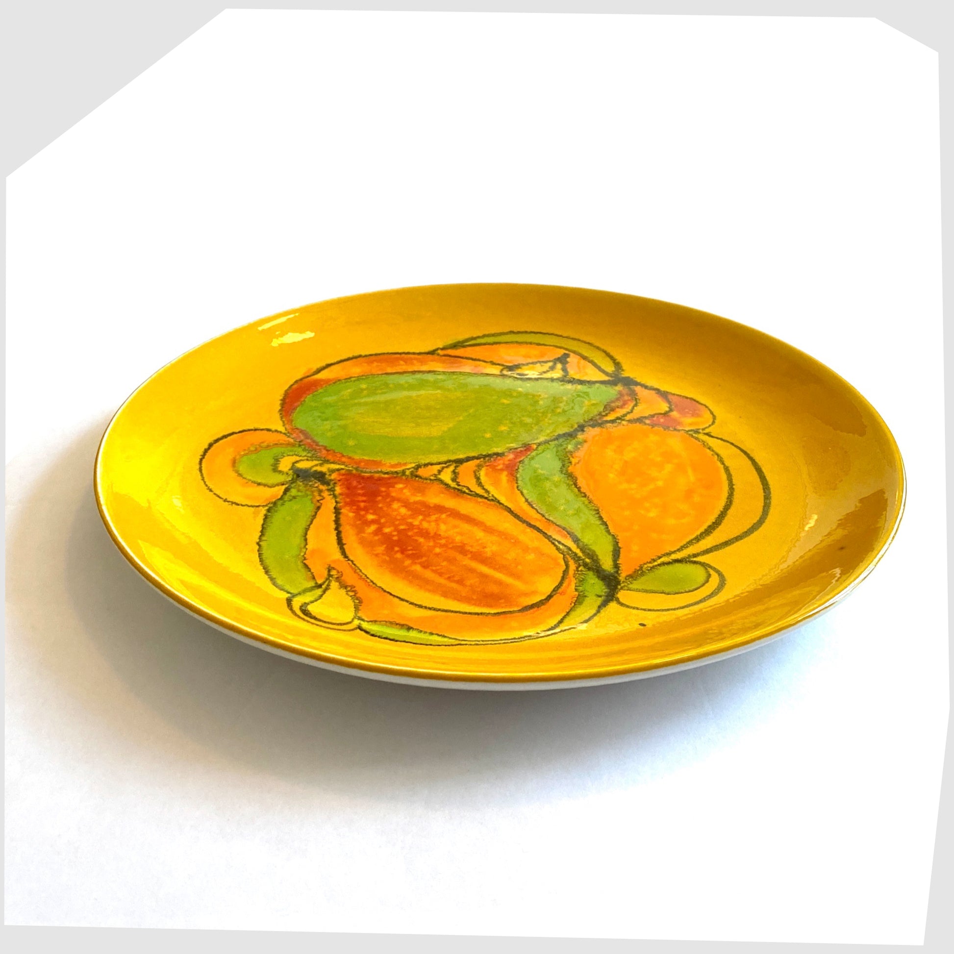 1960s Poole Pottery Delphis Plate, shape 4A, in a bold yellow glaze with flowing shapes of green, orange and red.