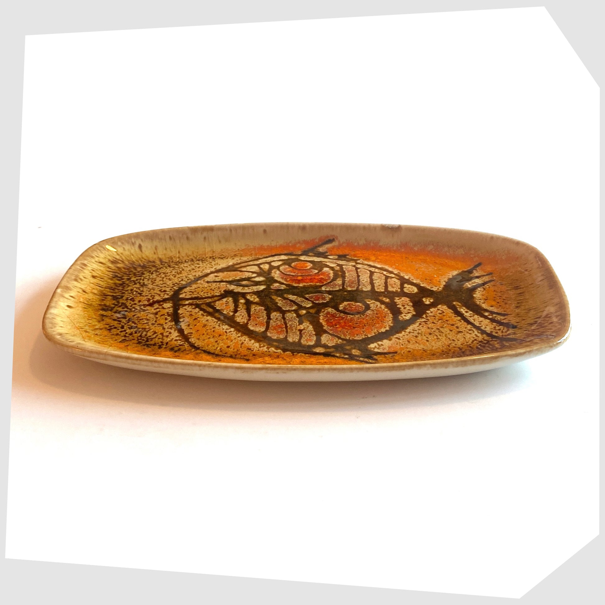 side profile of the Poole Pottery Shape 361 Pin Dish by Diana Davis, finished in the Aegean colour way with a striking fish design 
