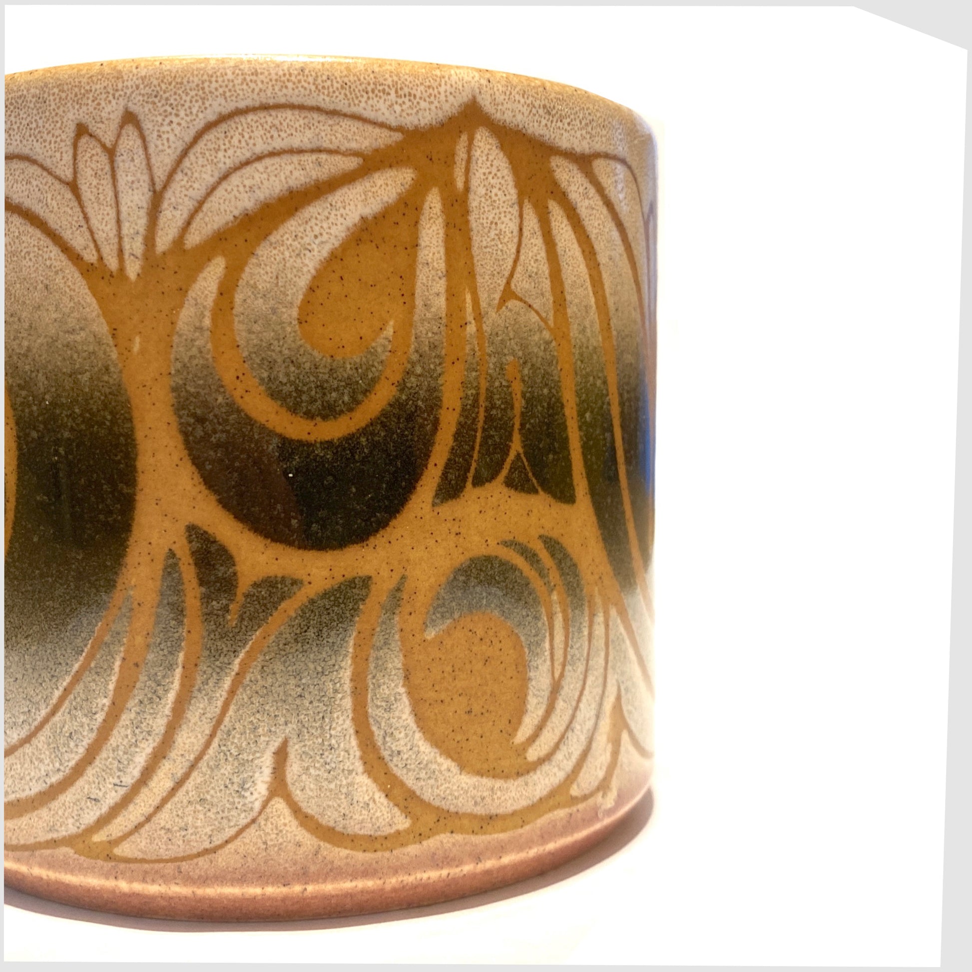 glazing detail on the poole pottery aegean planter, shape 497, cylindrical ceramic plant pot glazed in swirling orange lines