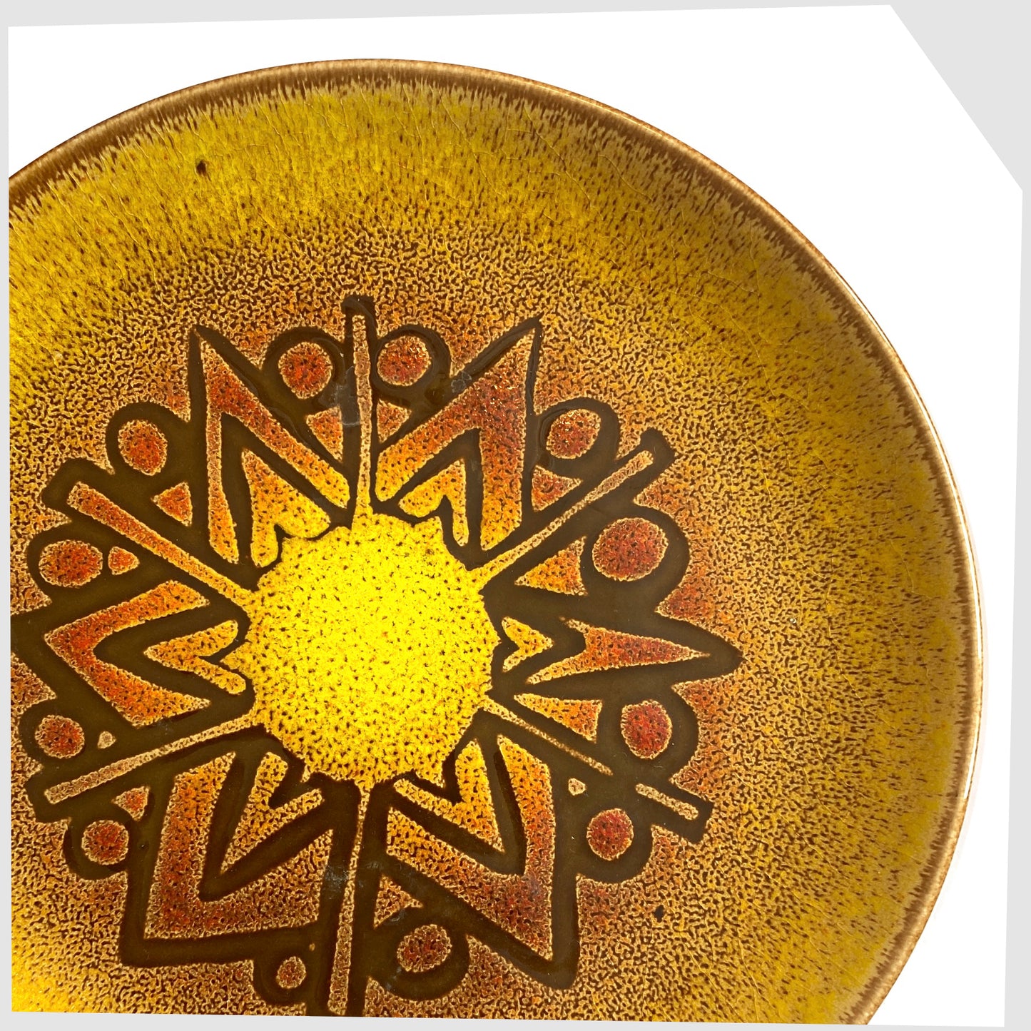 close up of the Poole Pottery Aegean Plate (10" diameter) in a rich yellow glaze with orange and brown circular design