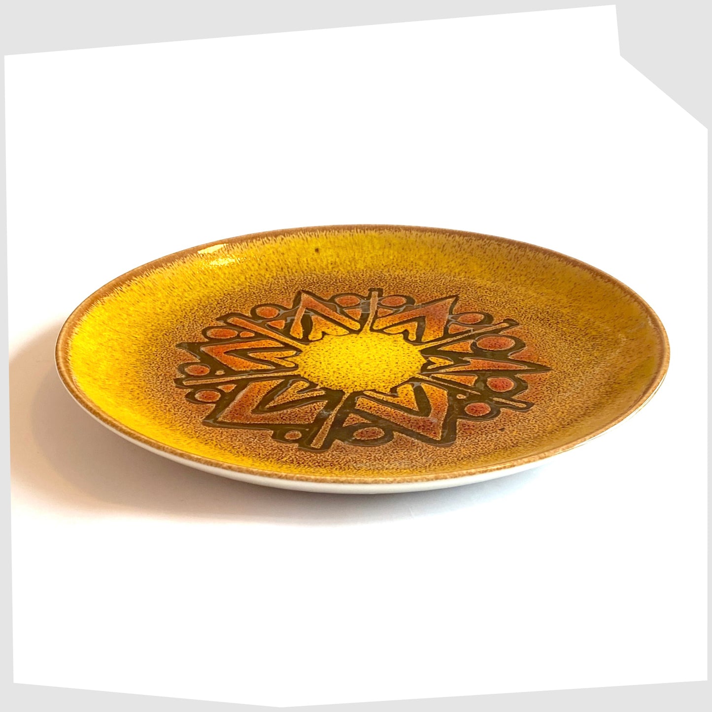 side of the Poole Pottery Aegean Plate (10" diameter) in a rich yellow glaze with orange and brown circular design