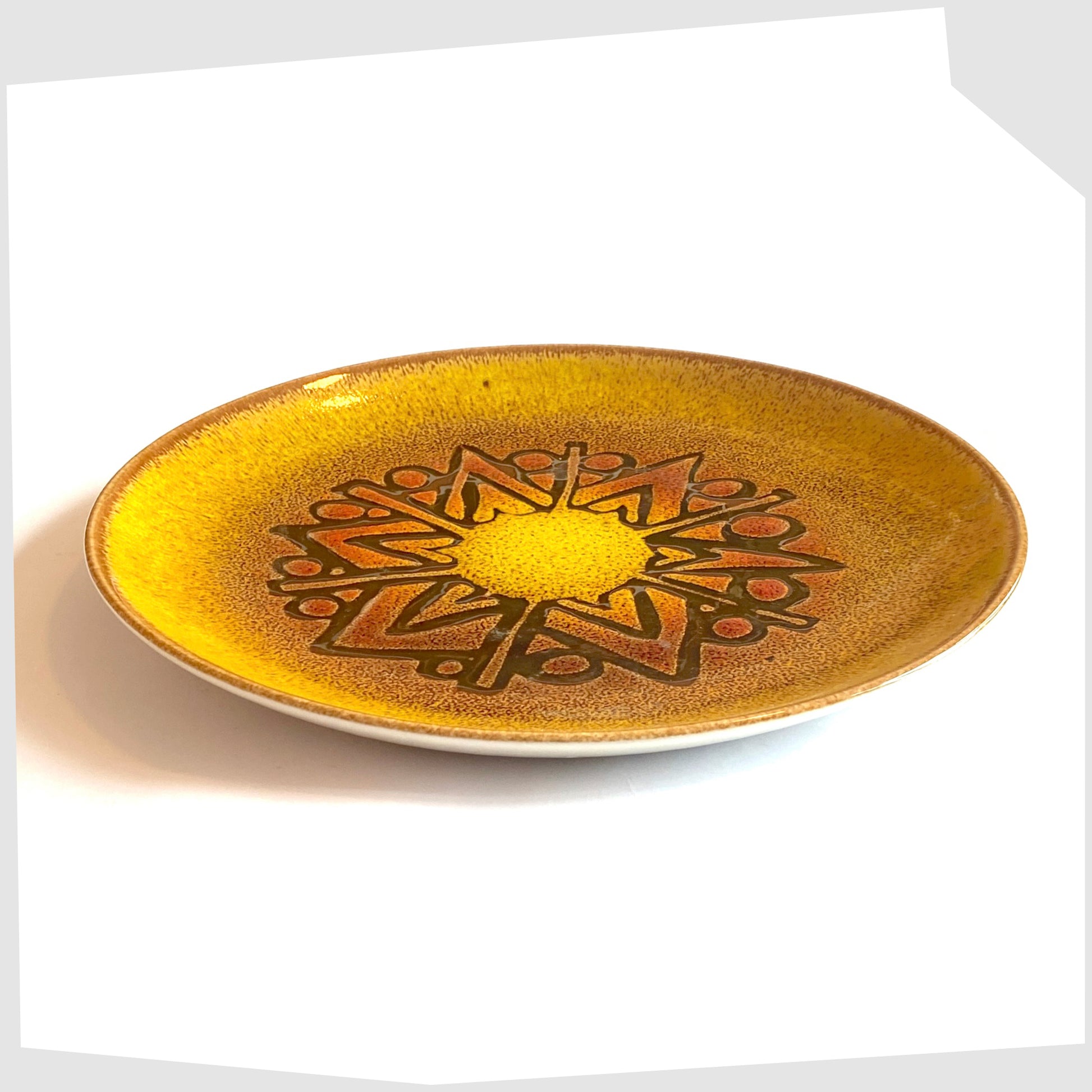 side of the Poole Pottery Aegean Plate (10" diameter) in a rich yellow glaze with orange and brown circular design