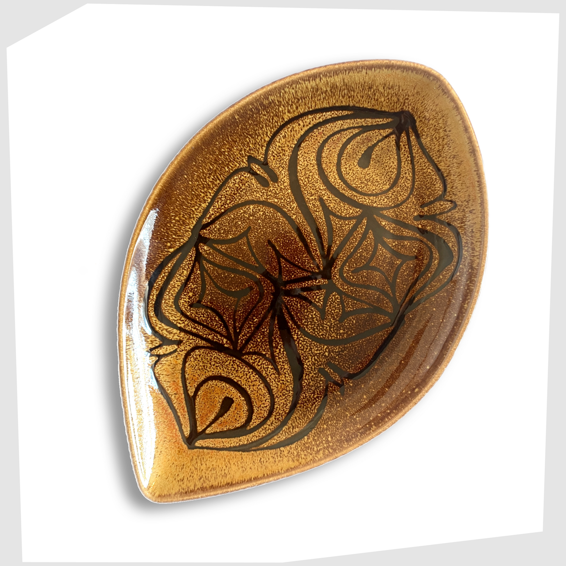 poole pottery teardrop dish, shape 91, decorated in poole's aegean glazing of black flowing lines on an amber and brown glaze